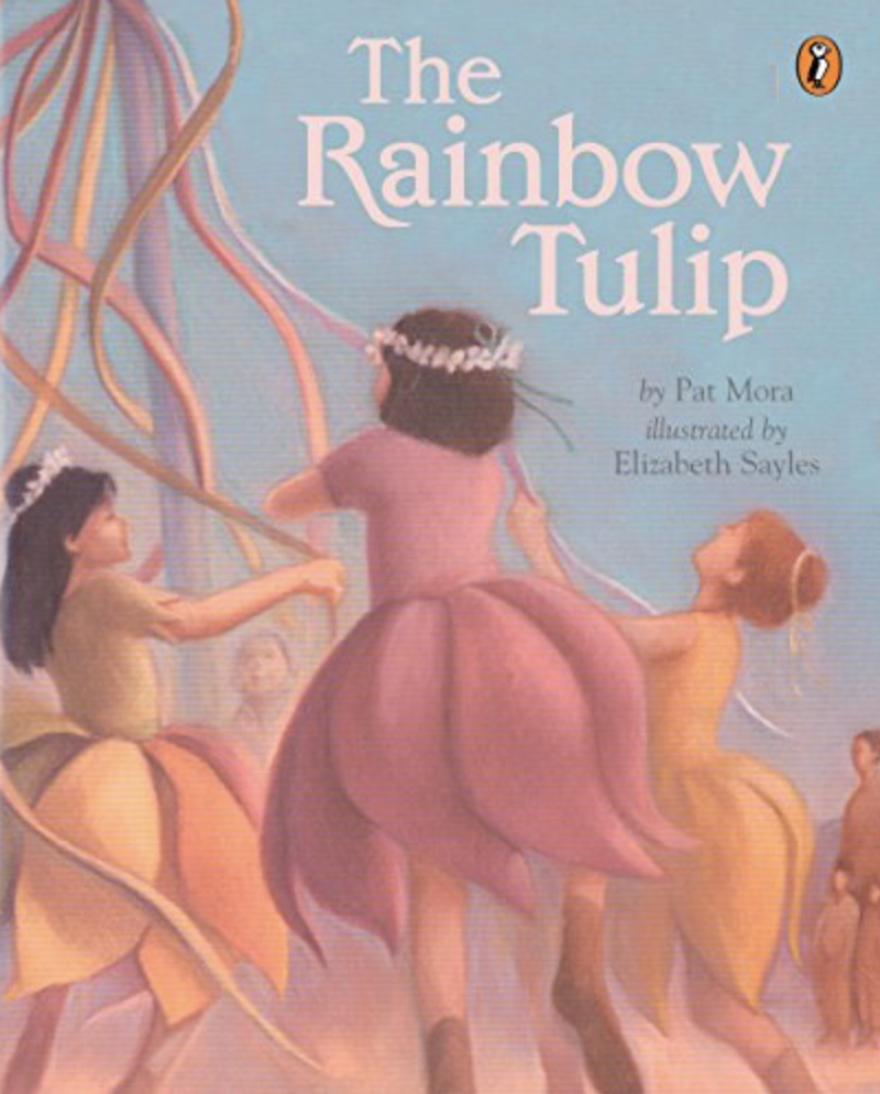 Illustrated book cover for Pat Mora's The Rainbow Tulip. Three girls in multi-colored tulip-shaped dresses frolic in a circle.
