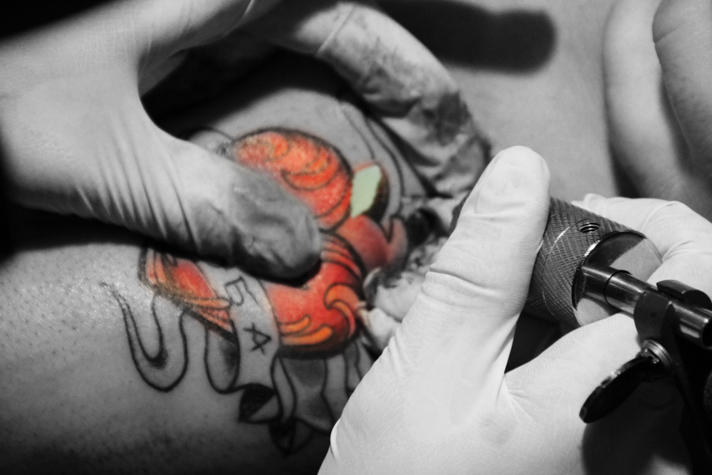 photograph of heart tattoo being done