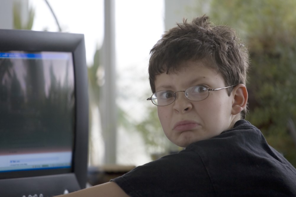 photograph of middle school boy using computer