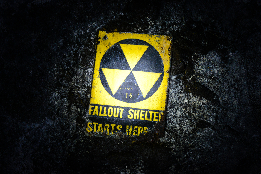 photograph of 'Fallout Shelter' sign in the dark