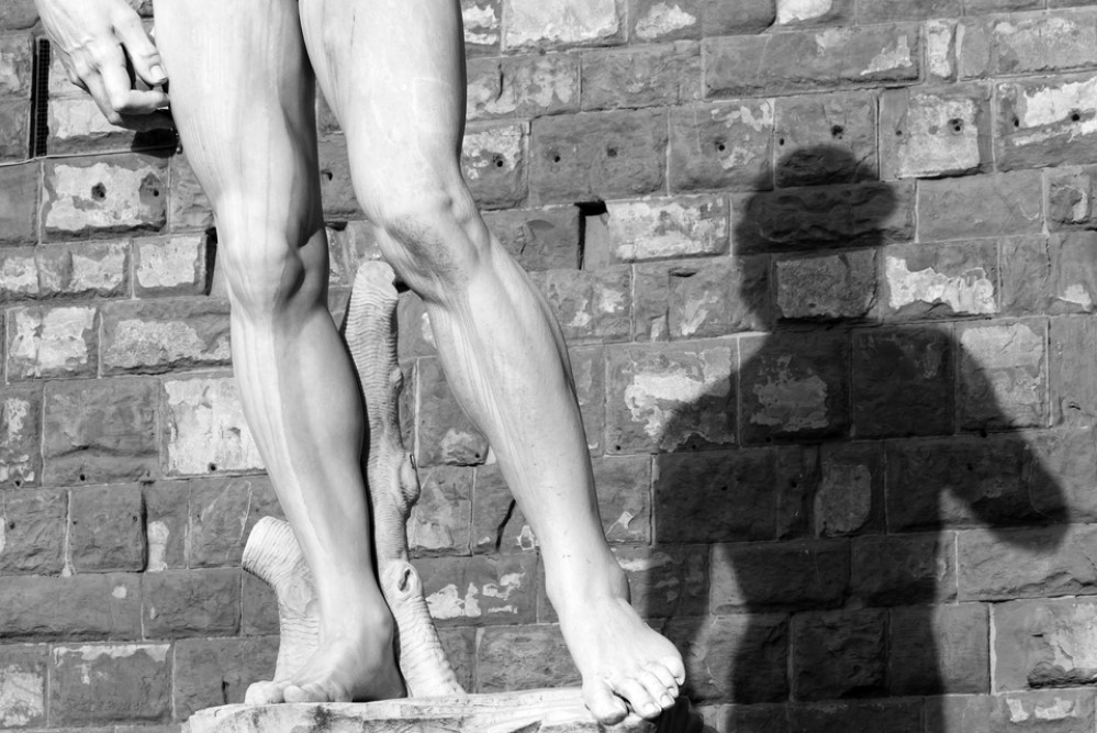 black and white photograph of David statue with shadow on wall