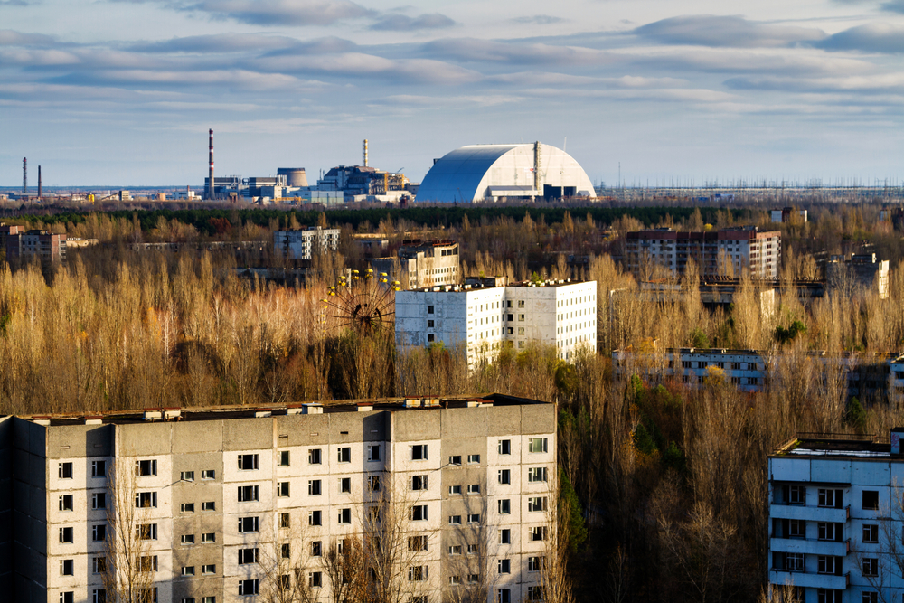 photograph of overgrown buildings in Chernobyl exclusion zone