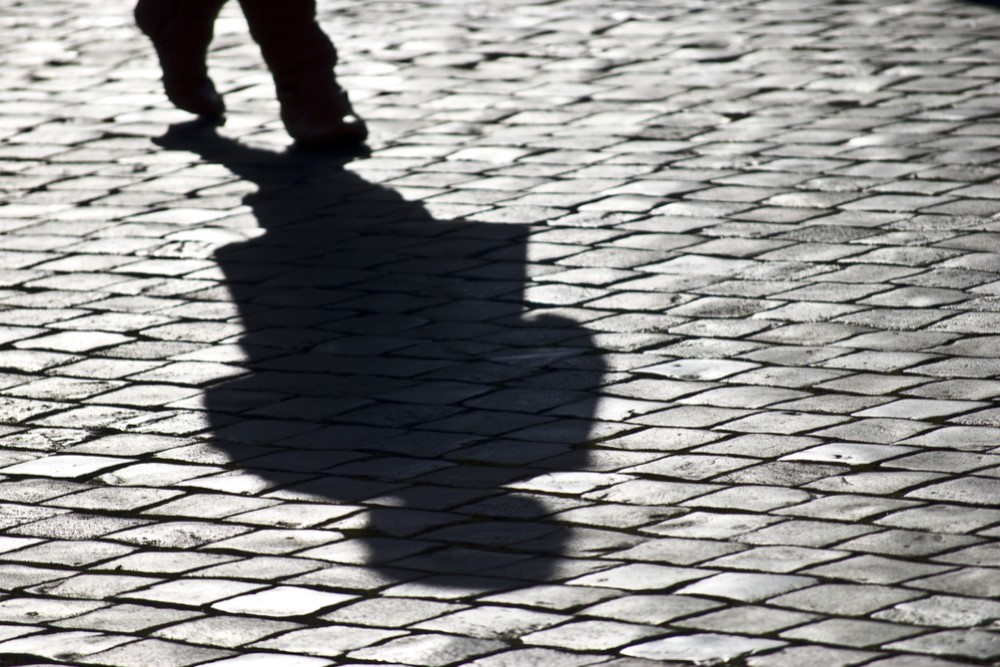 black and white photograph of shadow on sidewalk