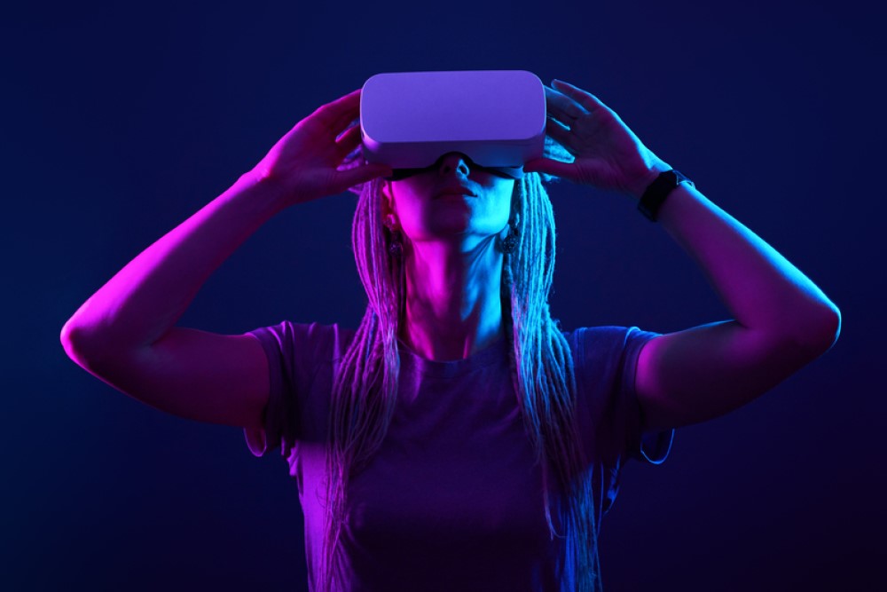 photograph of woman using VR headset