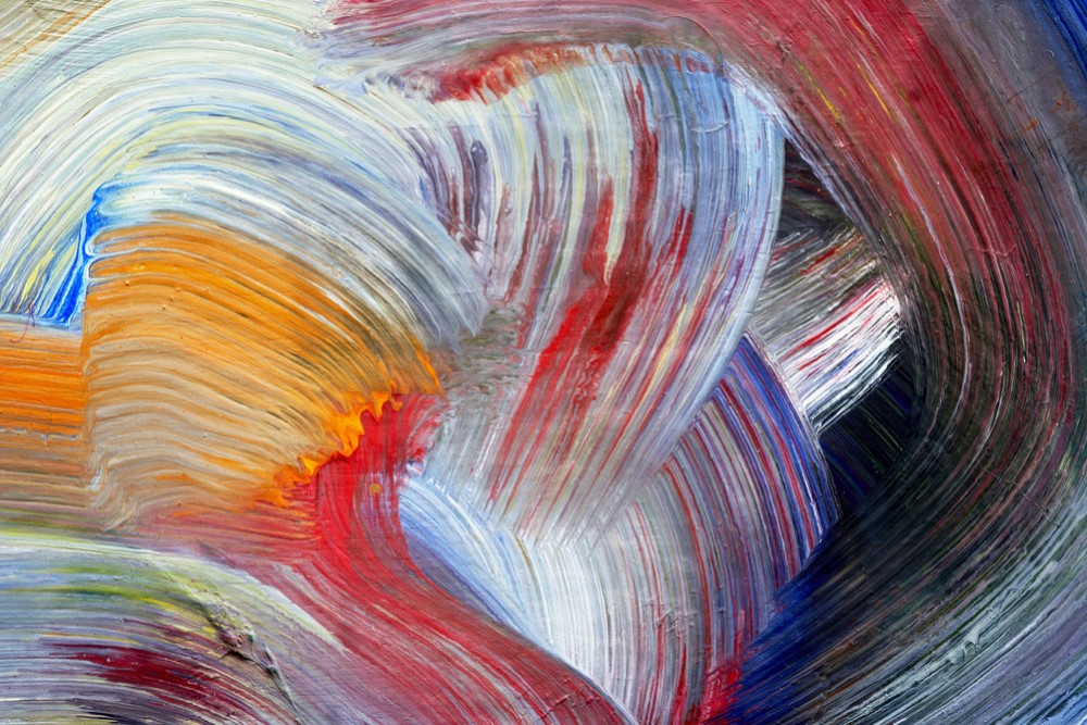 close-up photograph of multi-colored brush strokes on canvas
