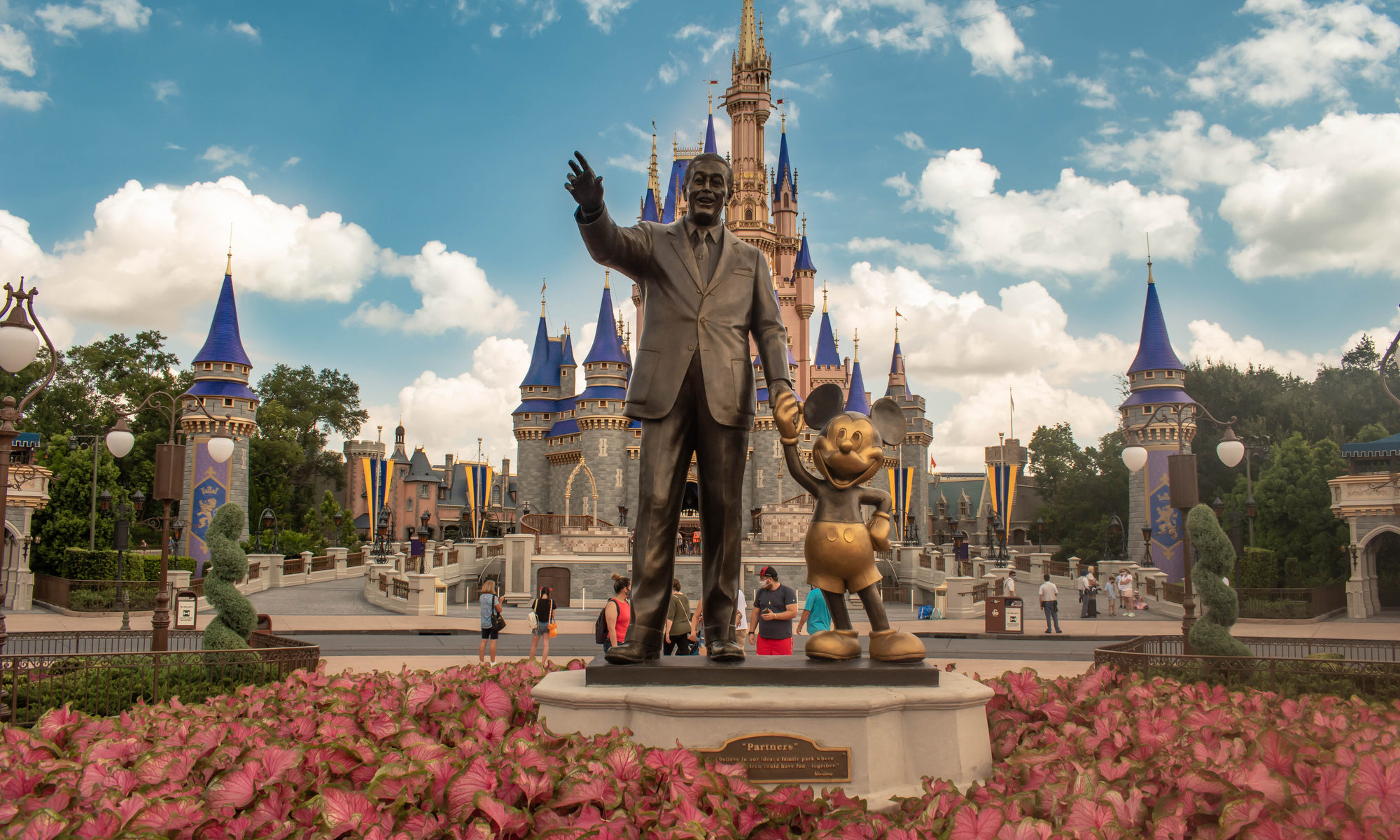 photograph of Disney and Mickey with castle in the background