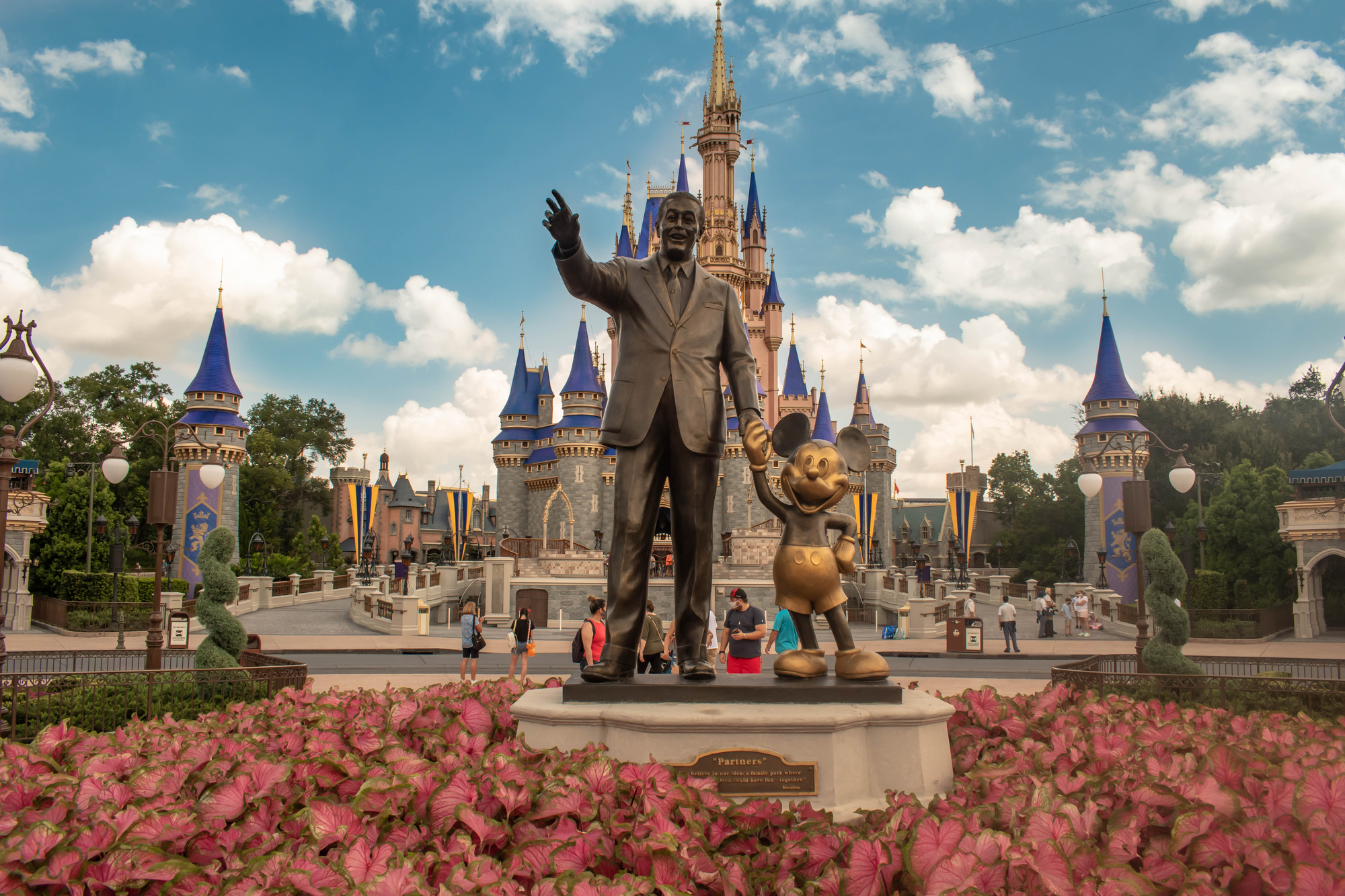 photograph of Disney and Mickey with castle in the background