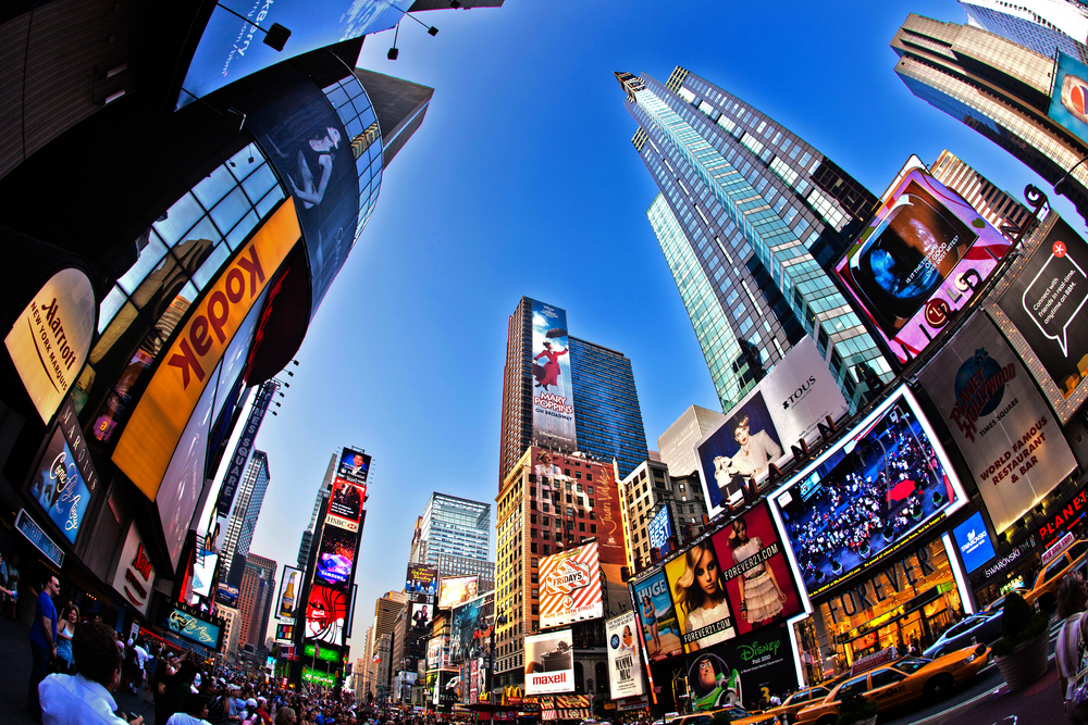 distorted photograph of Times Square building stretching into sky