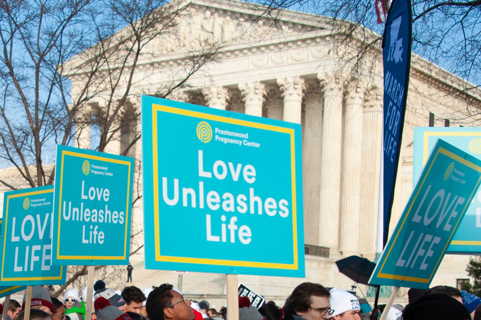 photograph of pro-life protest signs in front of Supreme Court