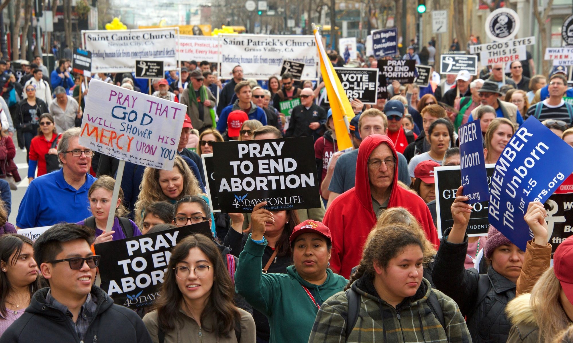 photograph of pro-life protesters with religious abortion signs