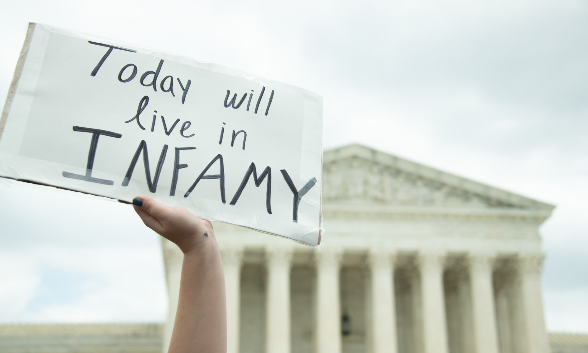 photograph of protest sign in fron of Supreme Court