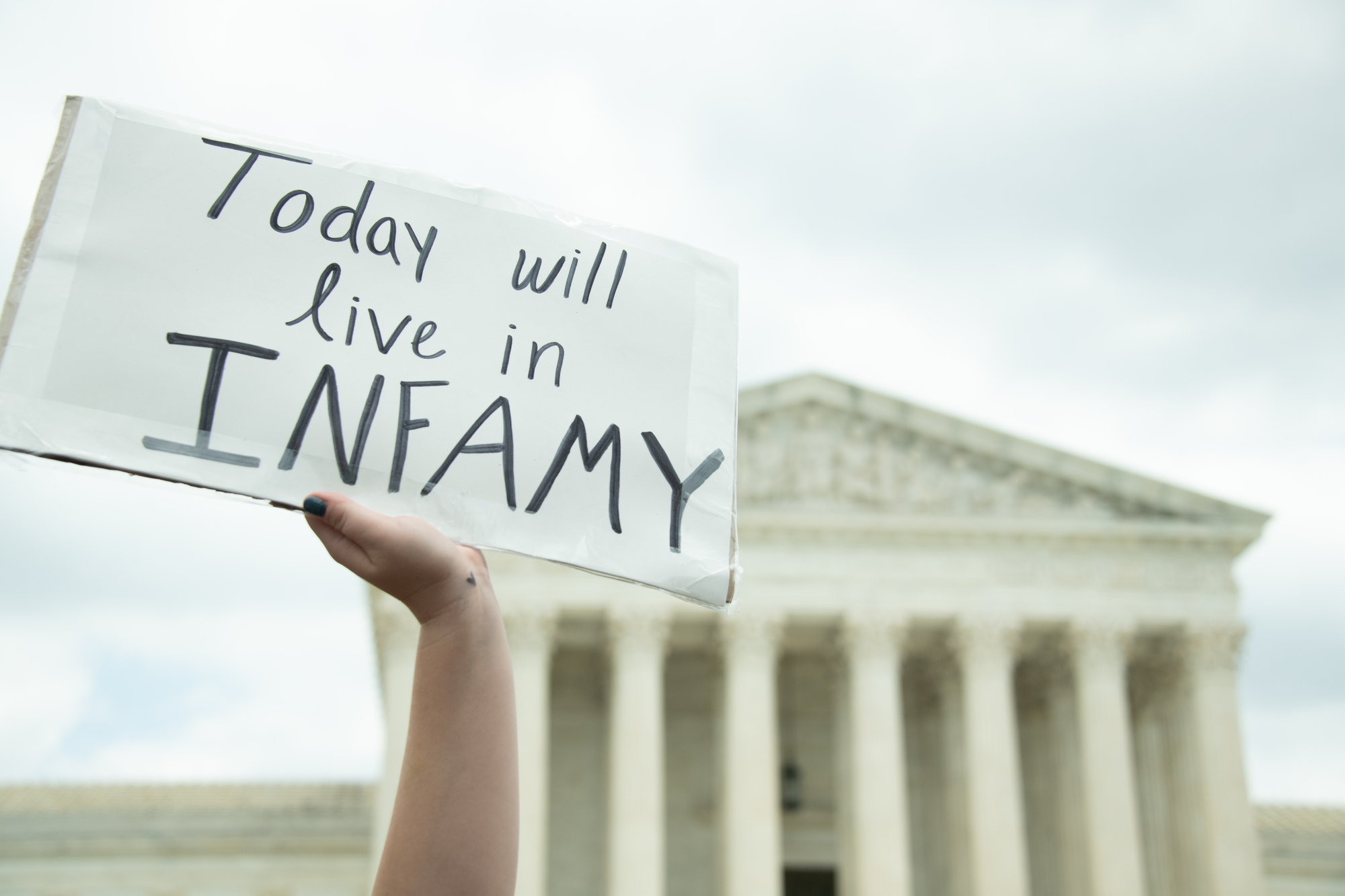 photograph of protest sign in fron of Supreme Court