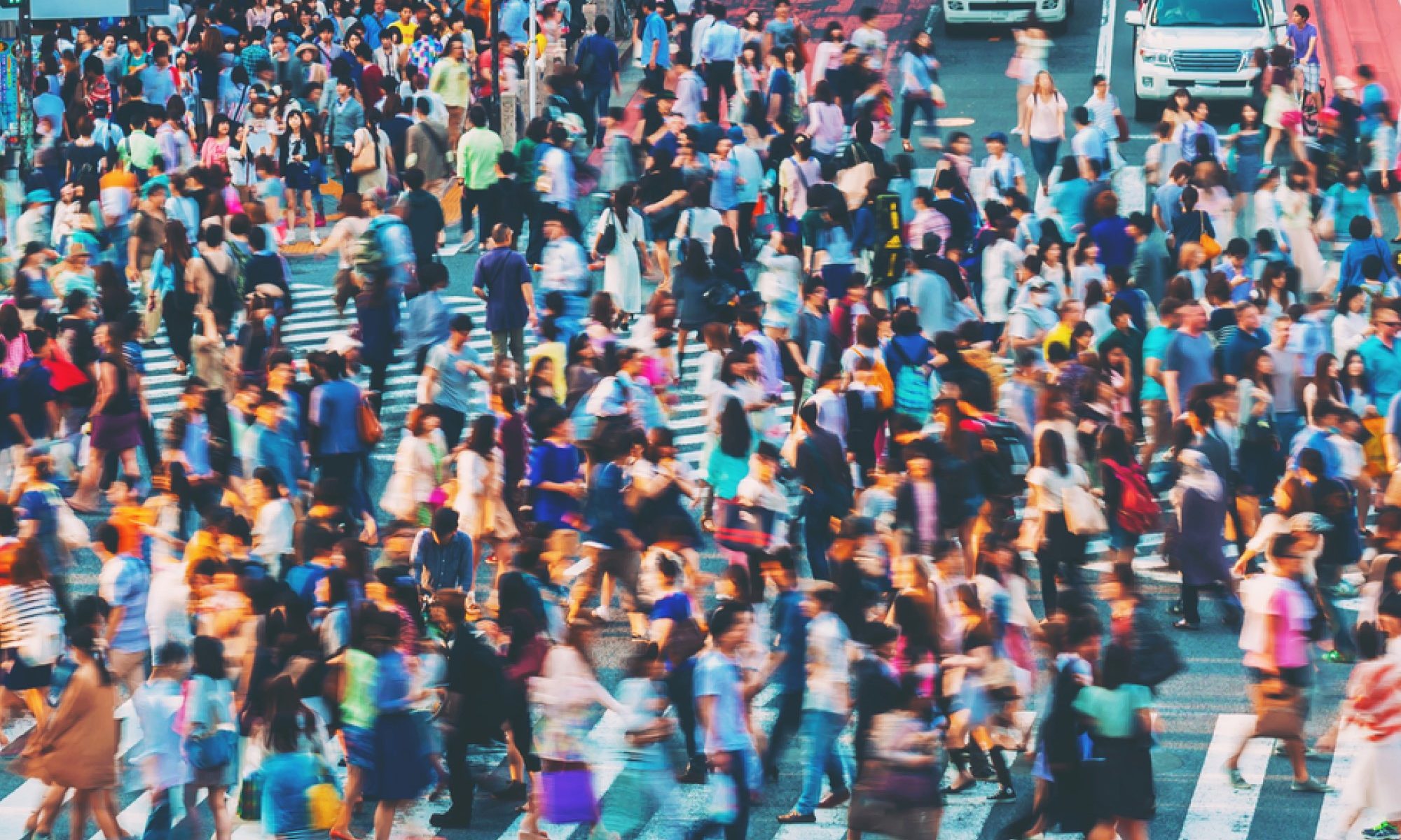 photograph of crowded pedestrian intersection