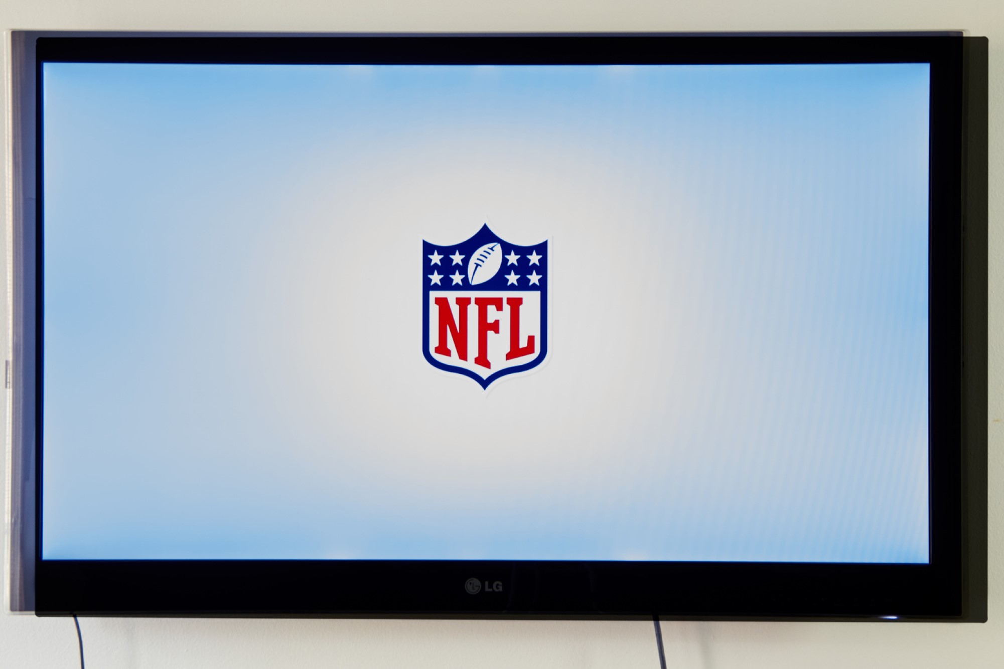 photograph of NFL logo on TV screen