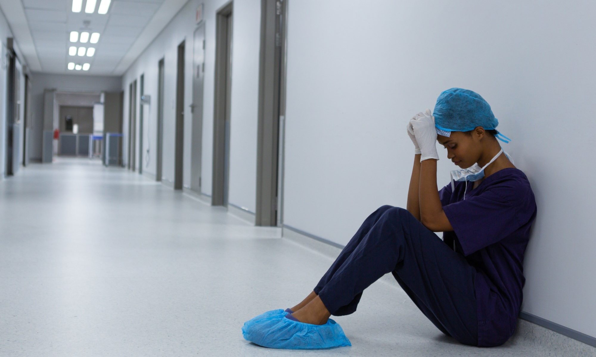 photograph of surgeon crying in hospital hallway