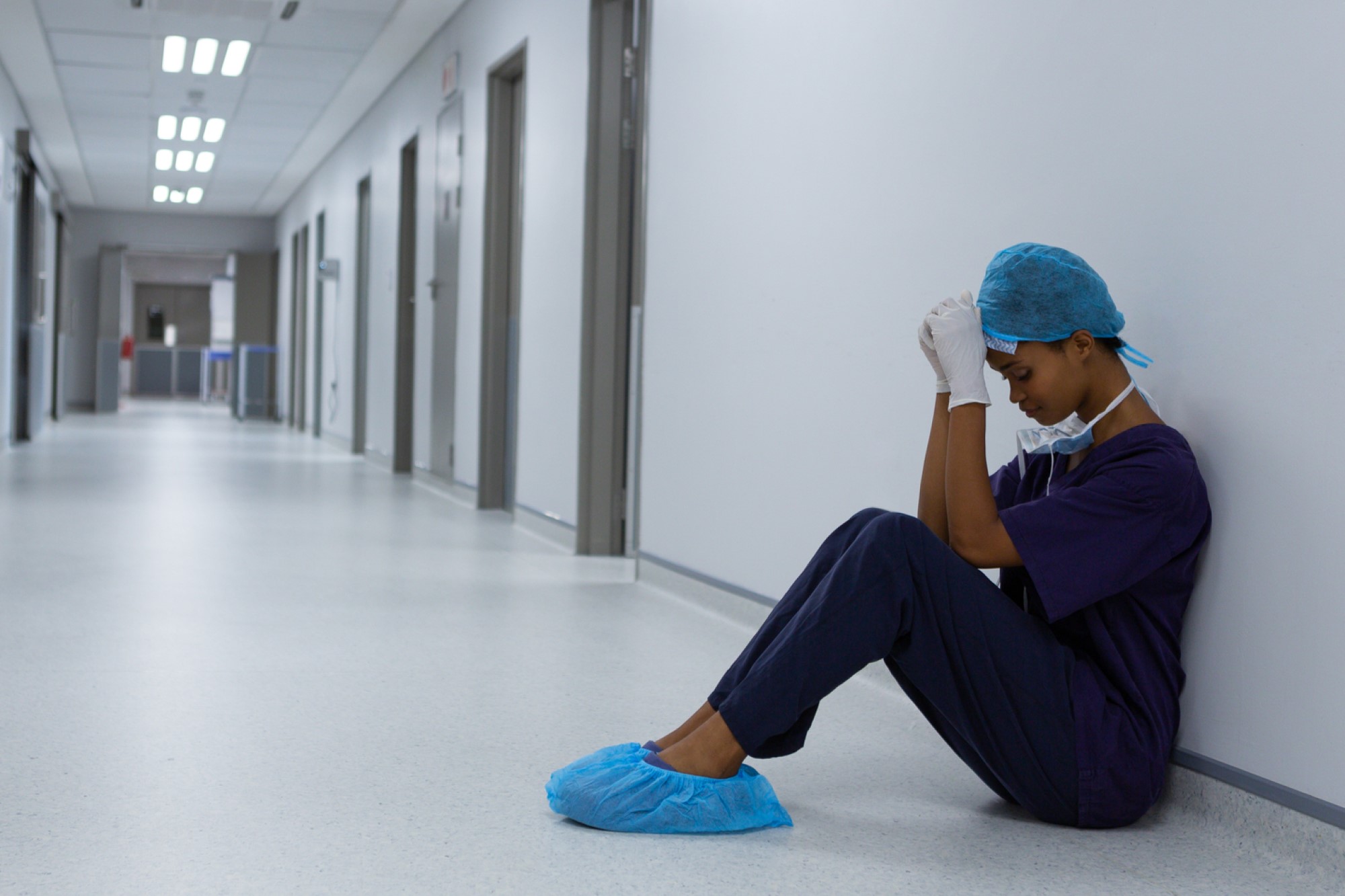 photograph of surgeon crying in hospital hallway