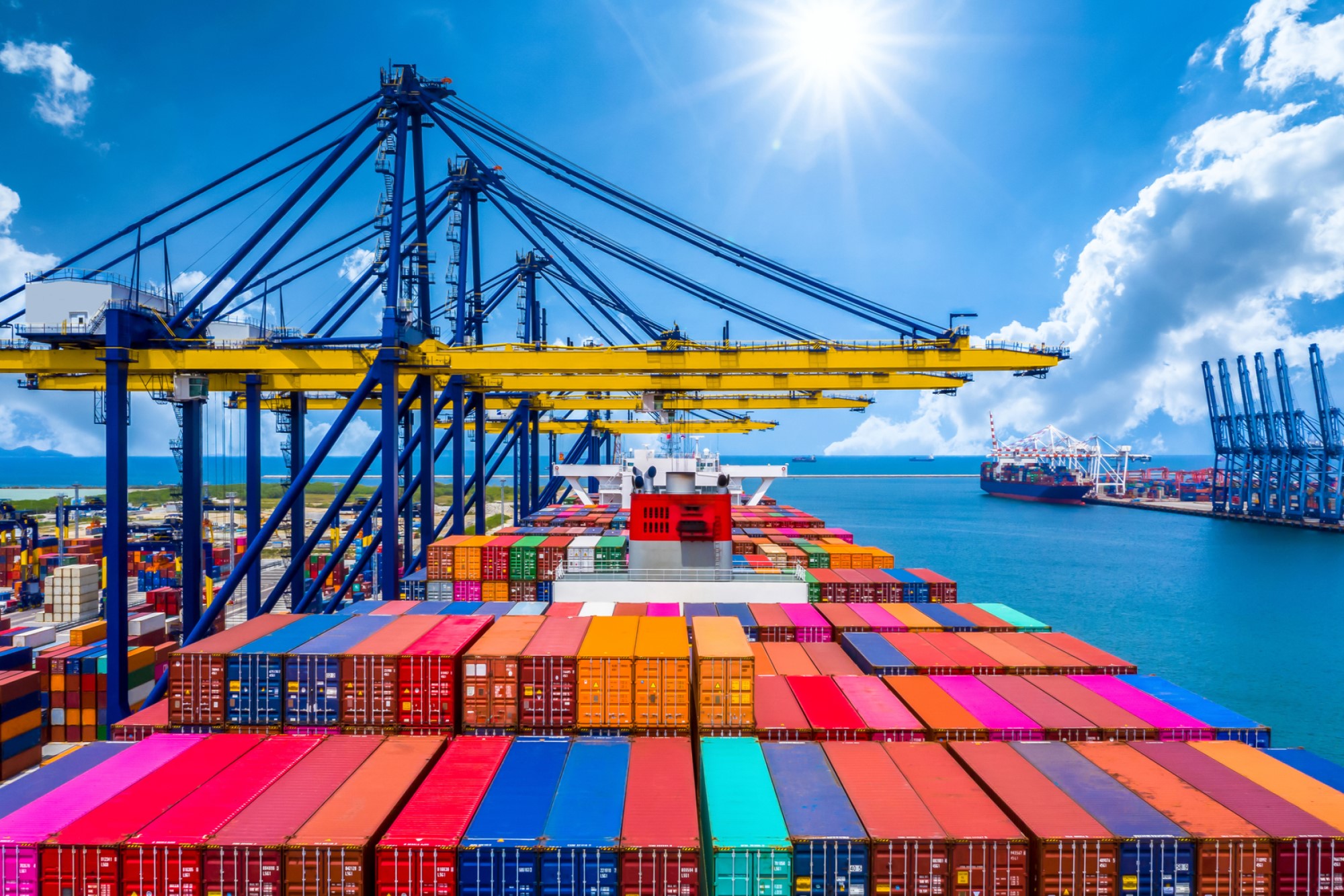 photograph of multi-colored shipping containers loaded on boat