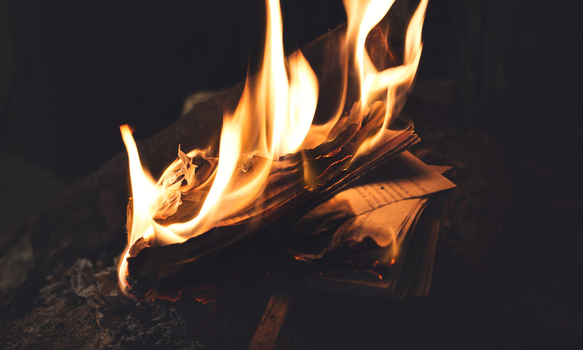 photograph of book burning in flames