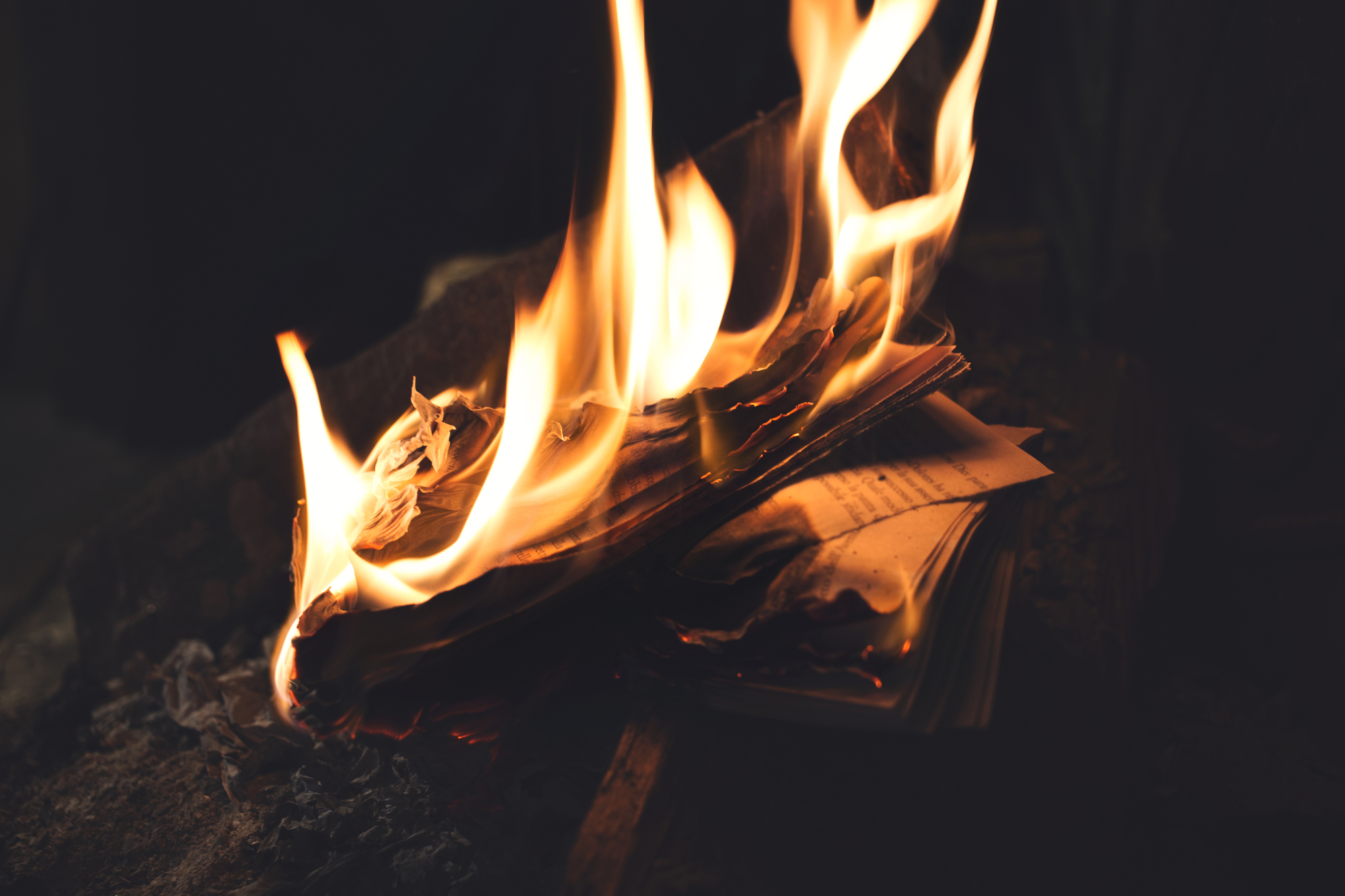 photograph of book burning in flames