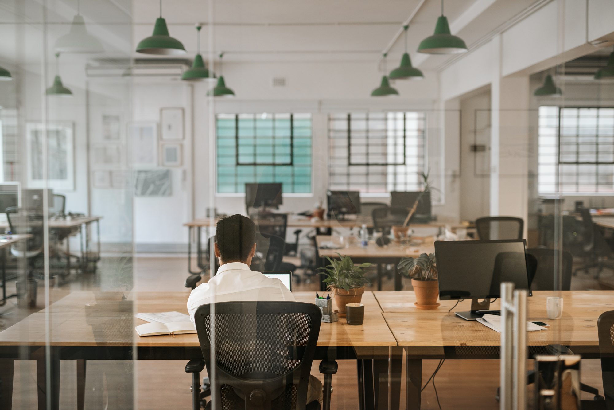 photograph of worker alone in empty office