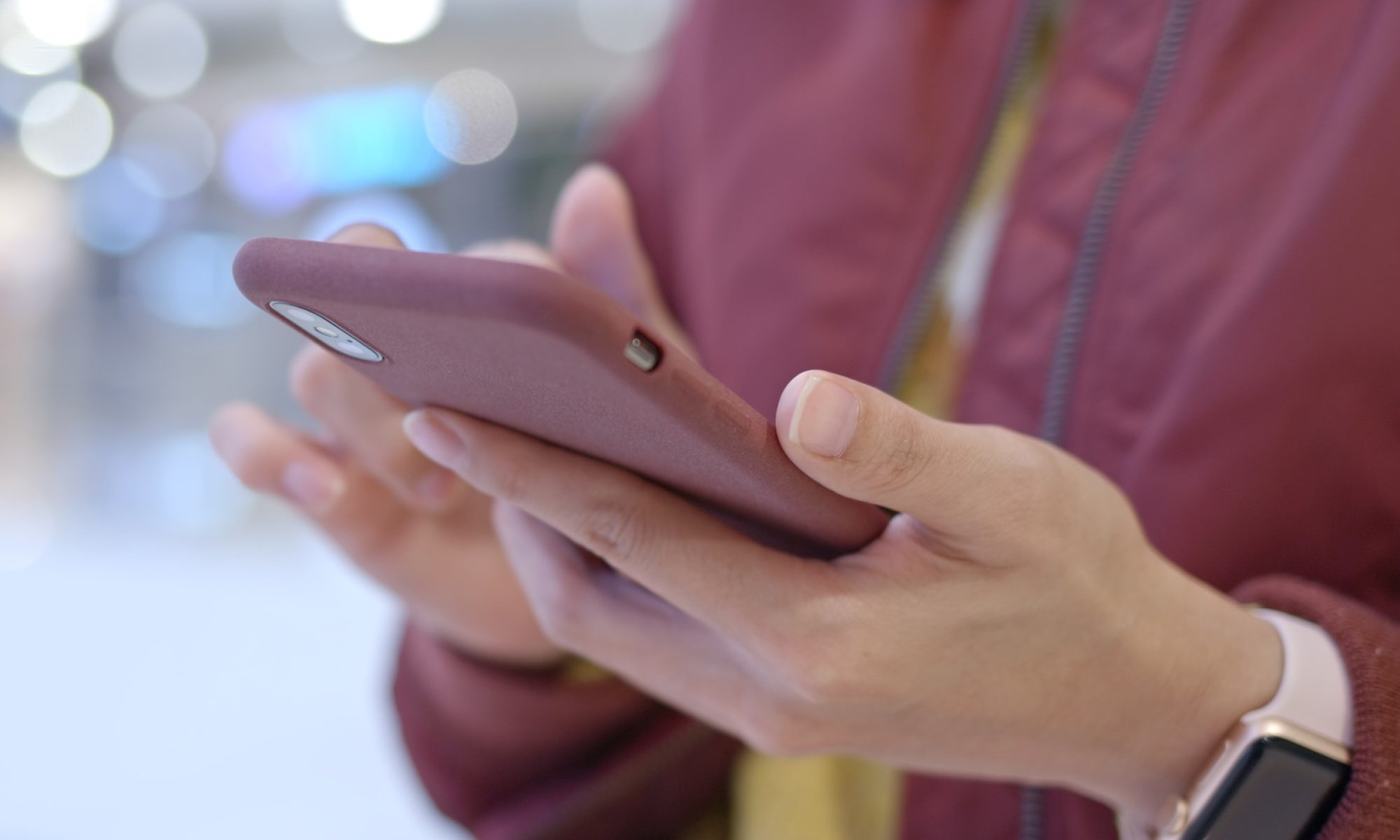 photograph of women using smartphone and wearing an Apple watch