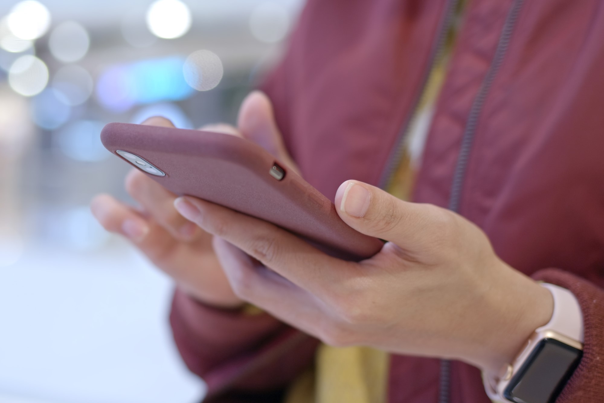 photograph of women using smartphone and wearing an Apple watch