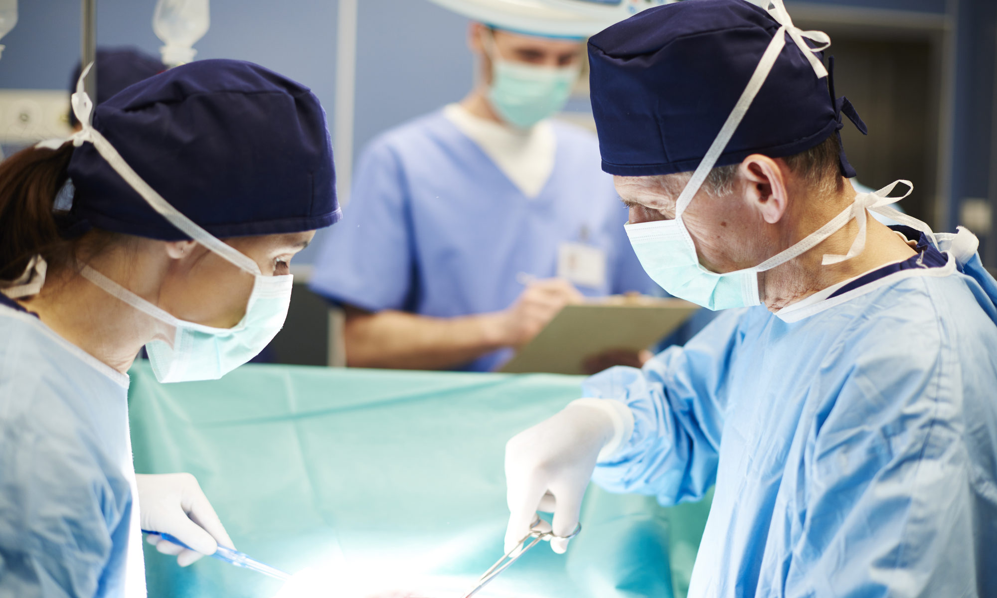 photograph of surgeons conducting procedure on operating table