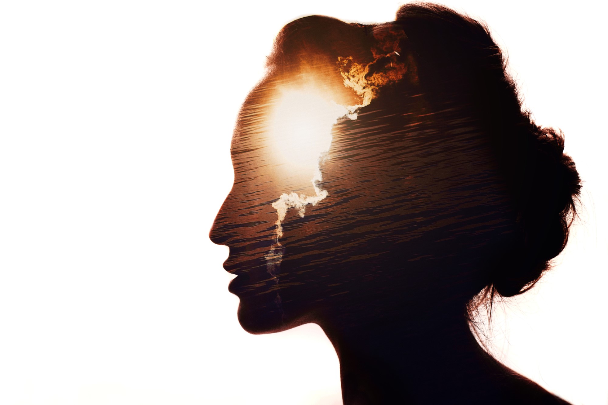 image of woman's profile in silhouette with sun behind clouds superimposed on her mind