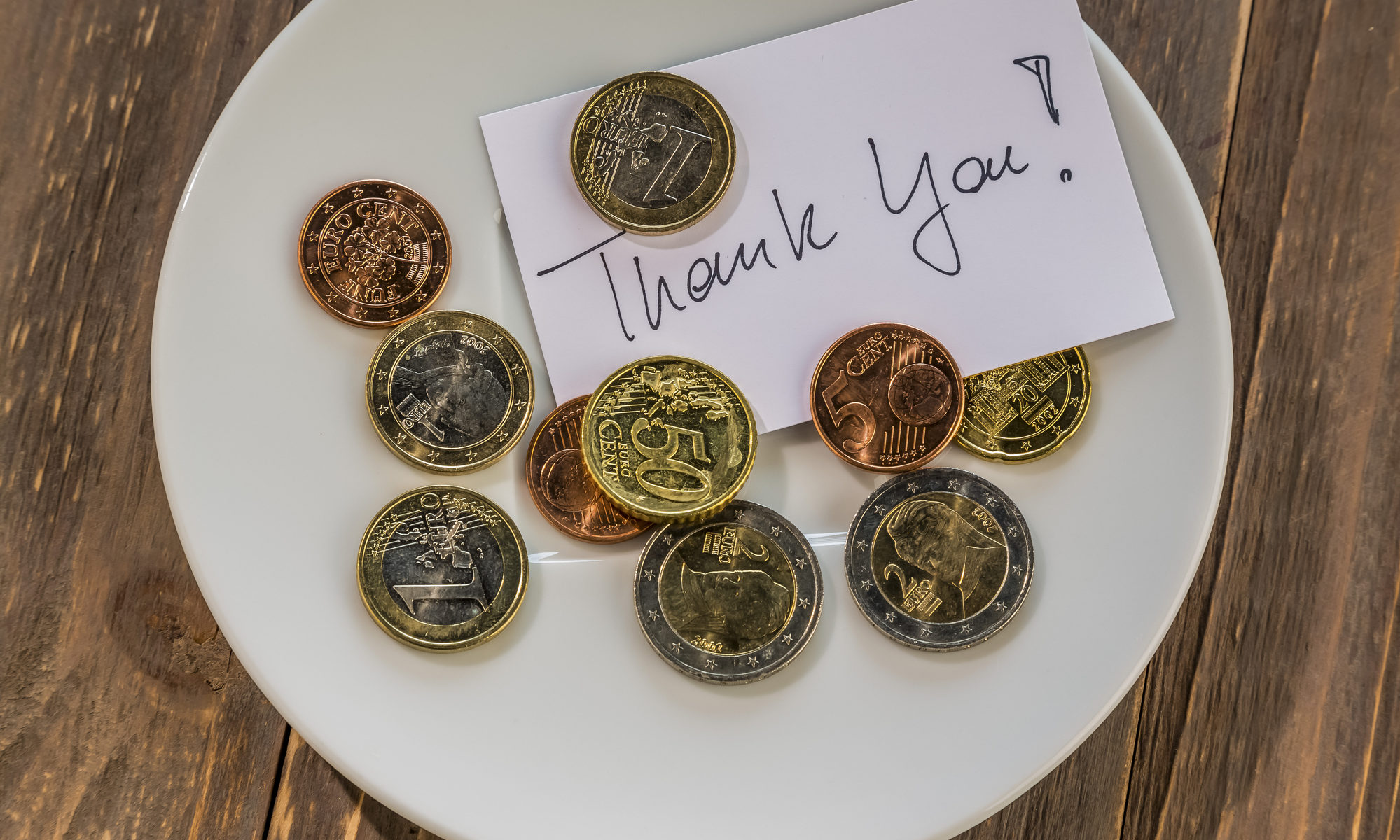 photograph of coin tip with "thank you" note