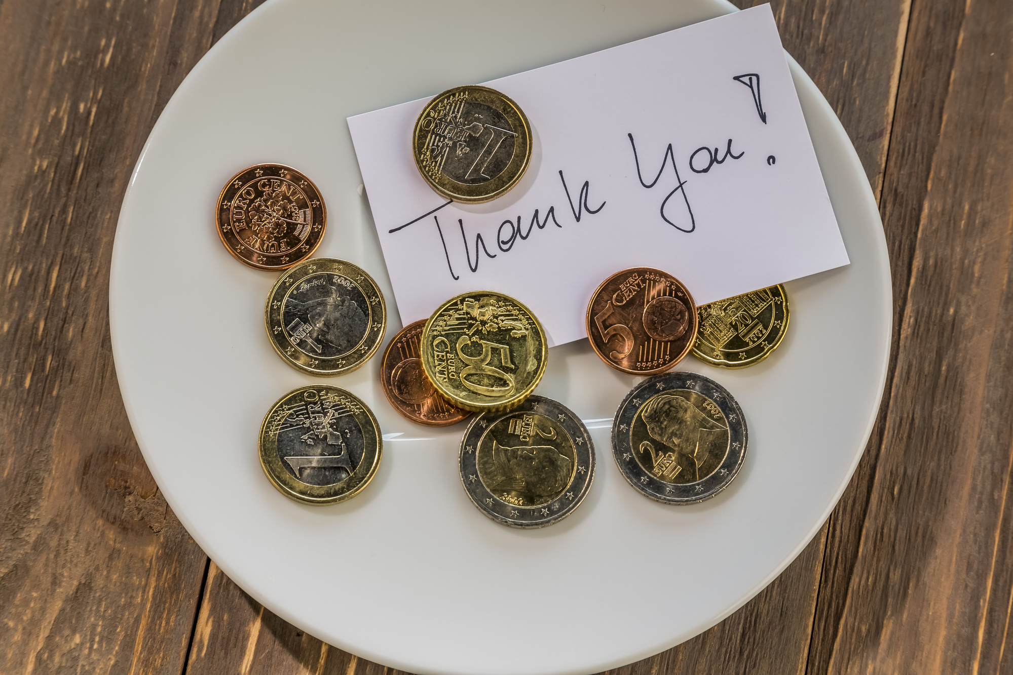 photograph of coin tip with "thank you" note