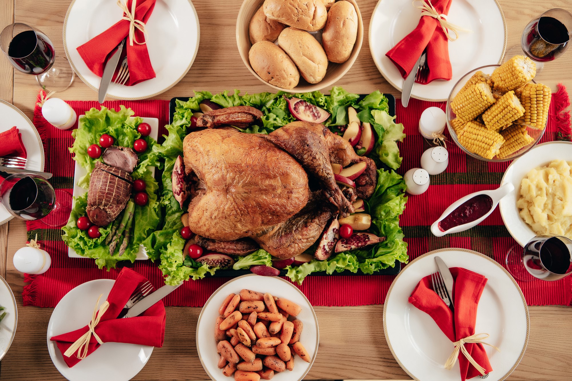 top-down photograph of holiday table set with turkey and sides