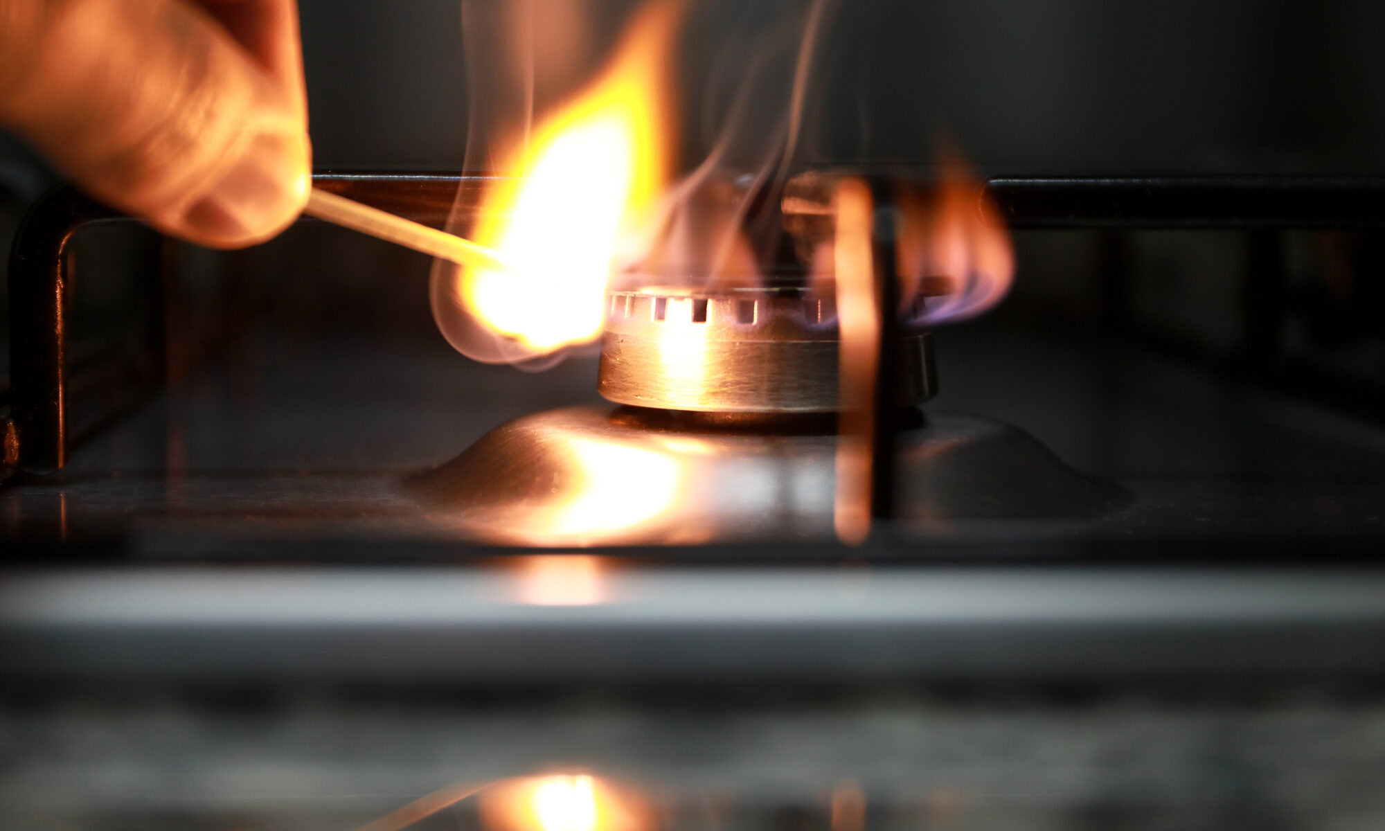 photograph of gas burner being lit