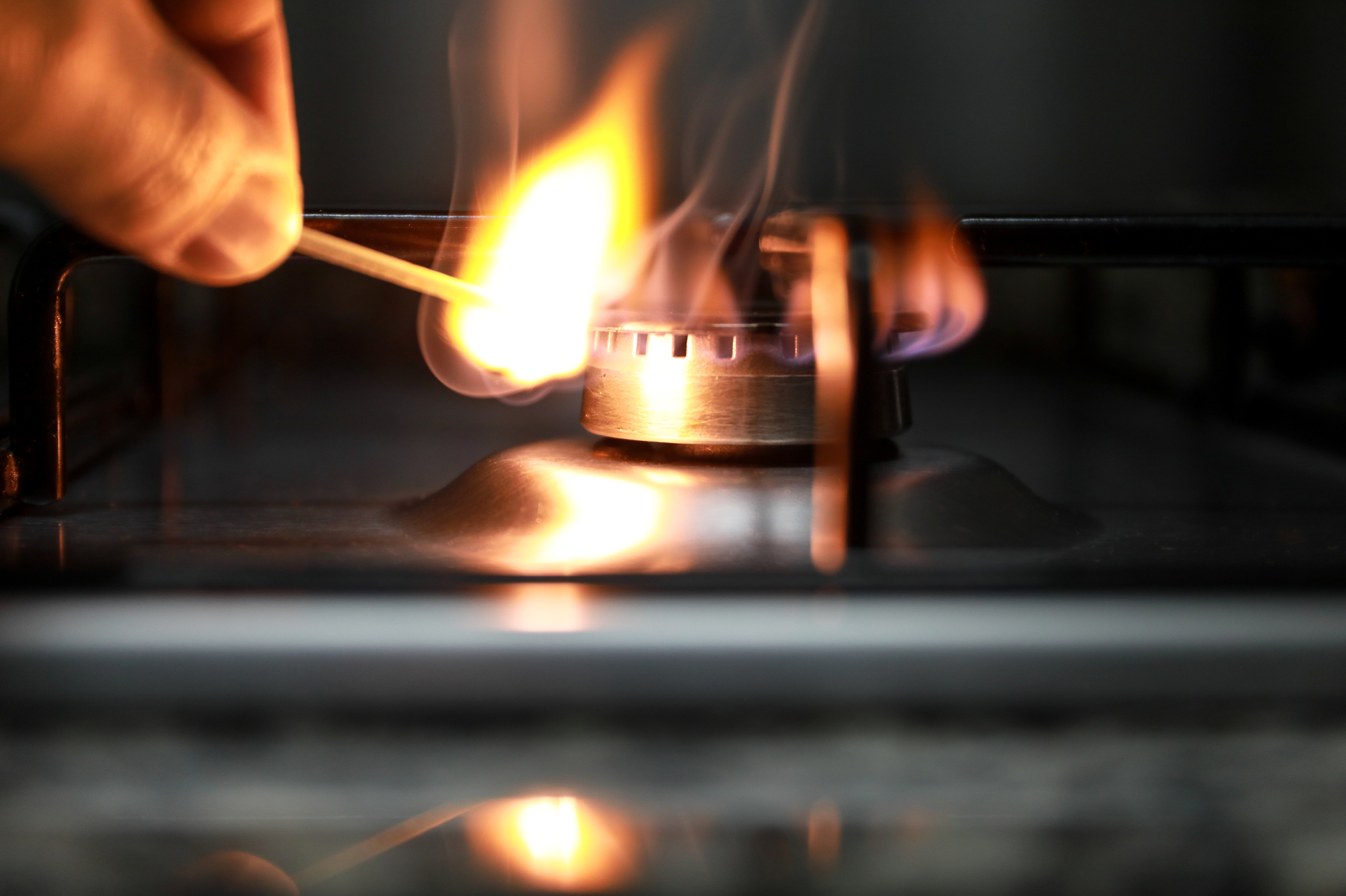 photograph of gas burner being lit