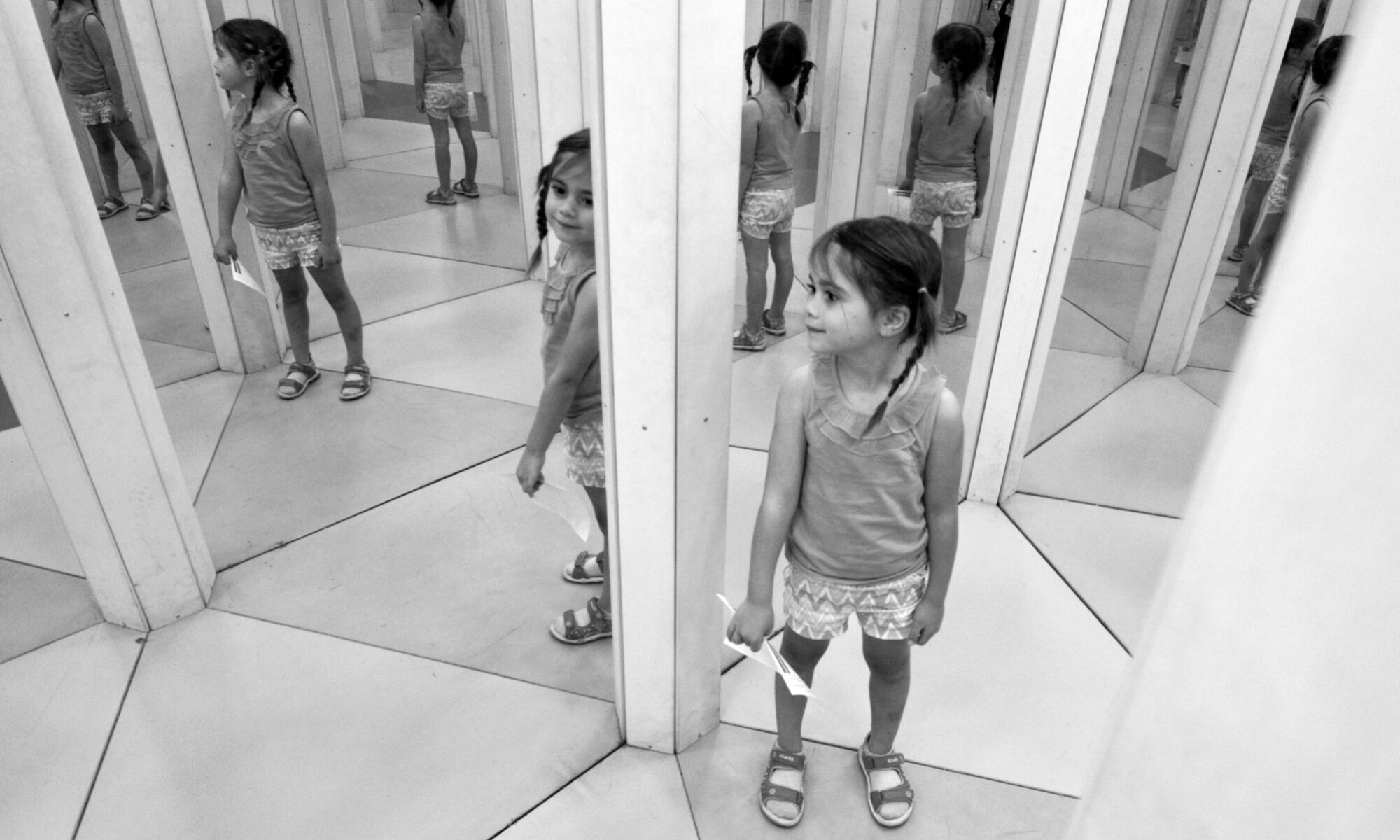 photograph of girl in mirror maze