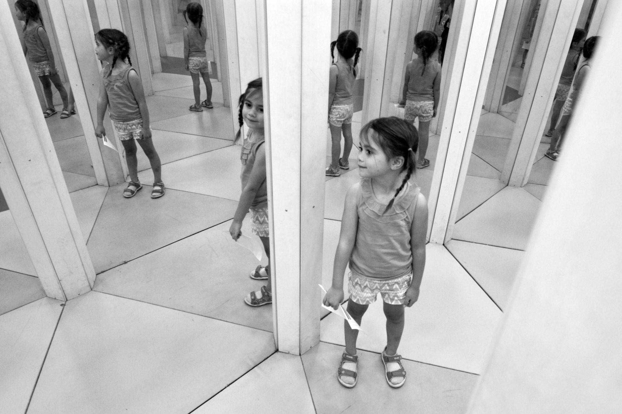 photograph of girl in mirror maze