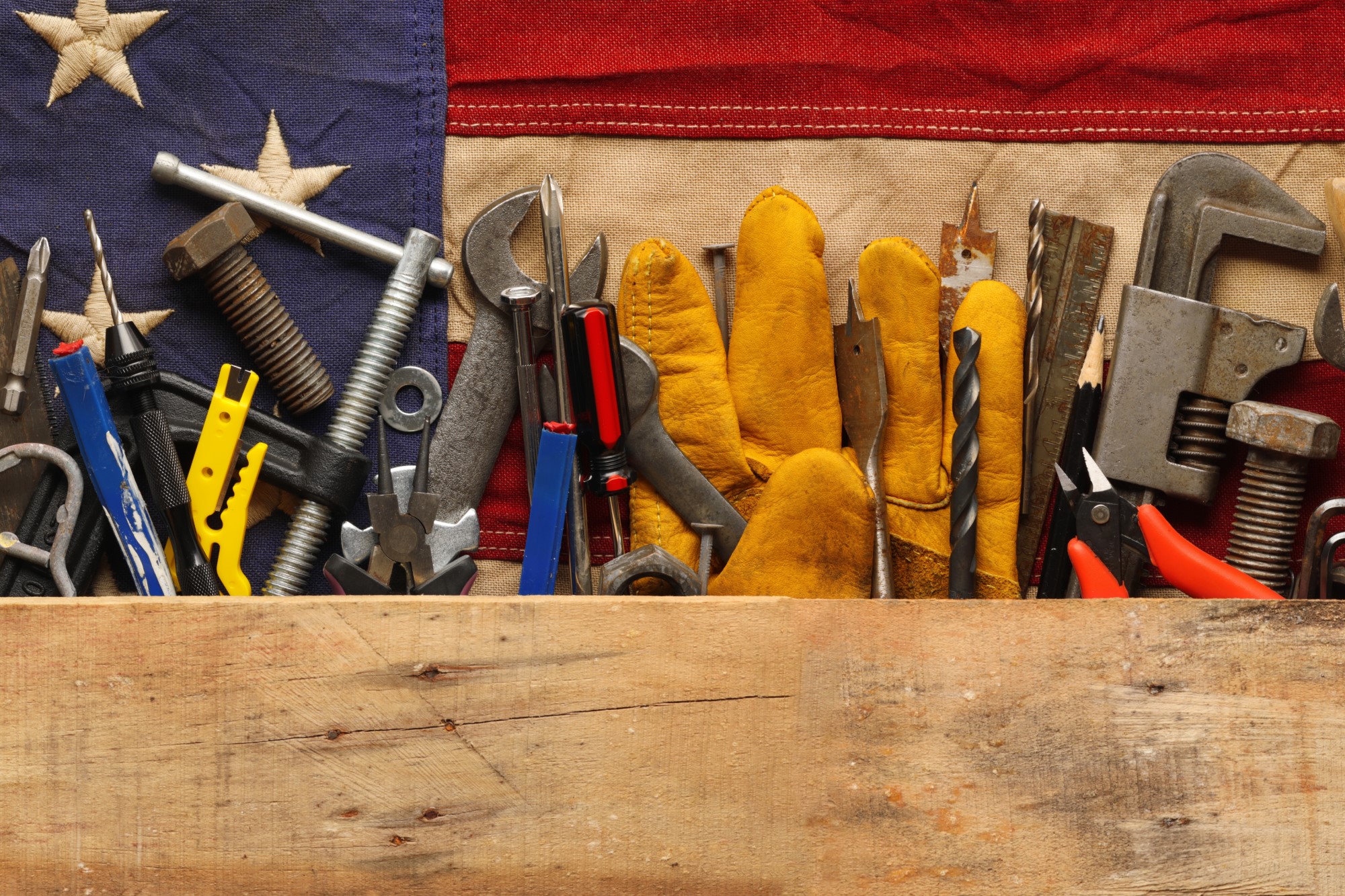 photograph of worker's tools arranged with US flag background