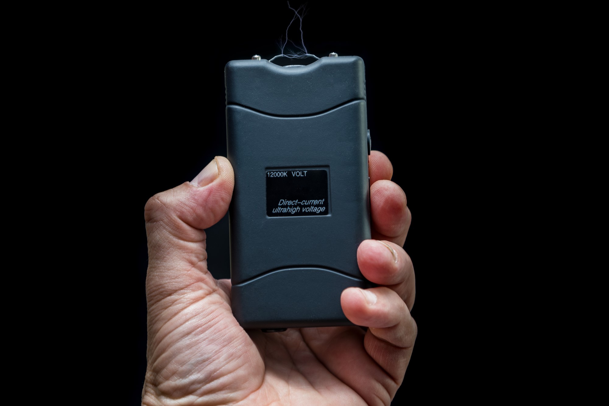 photograph of stun gun held up by hand