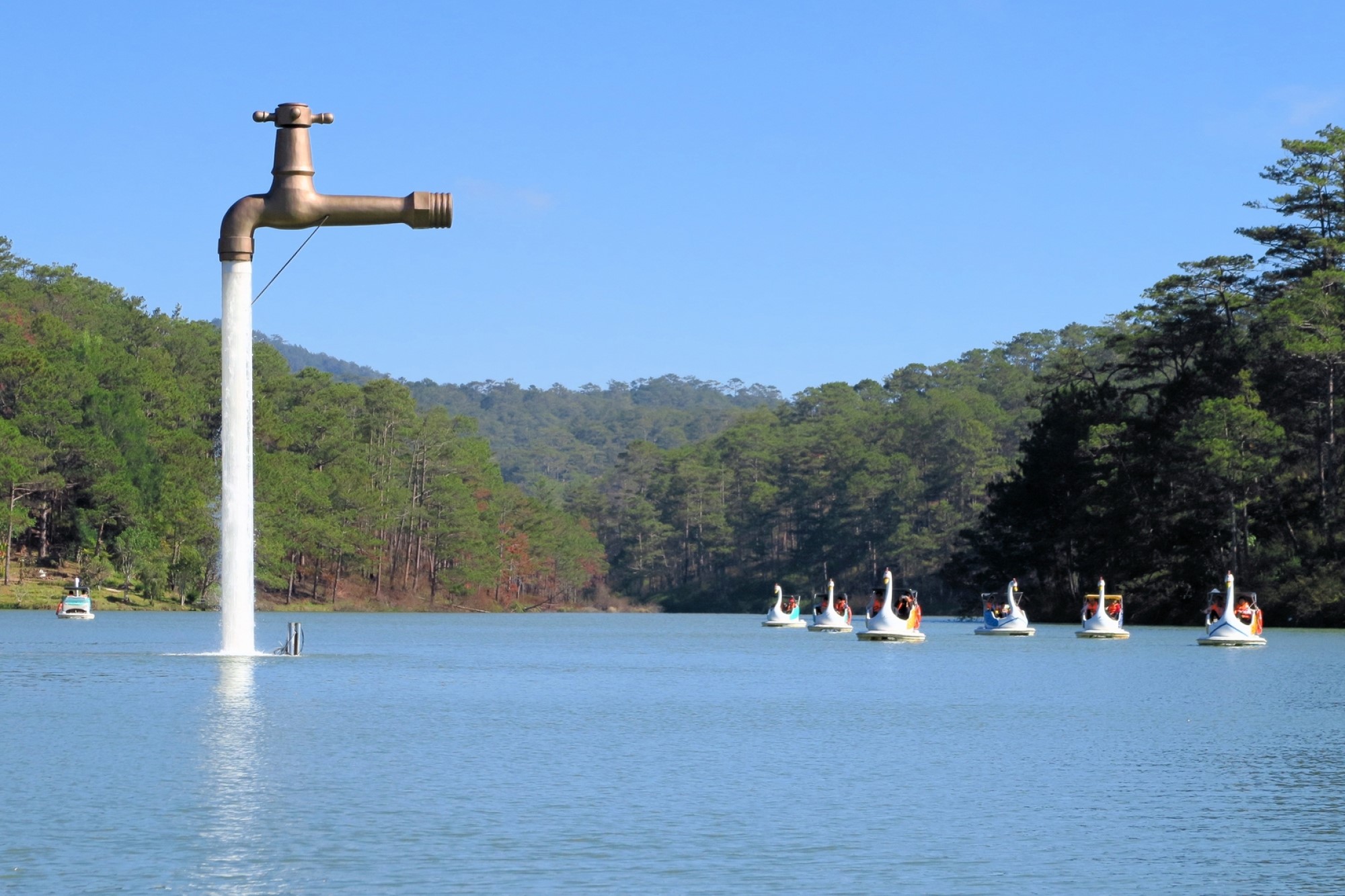 photograph of freestanding faucet on lake