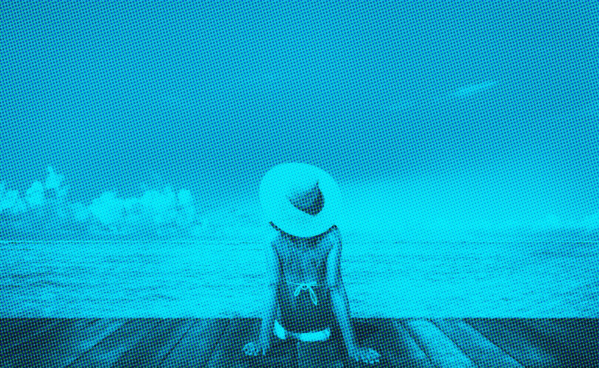 digitized image of woman relaxing on beach dock