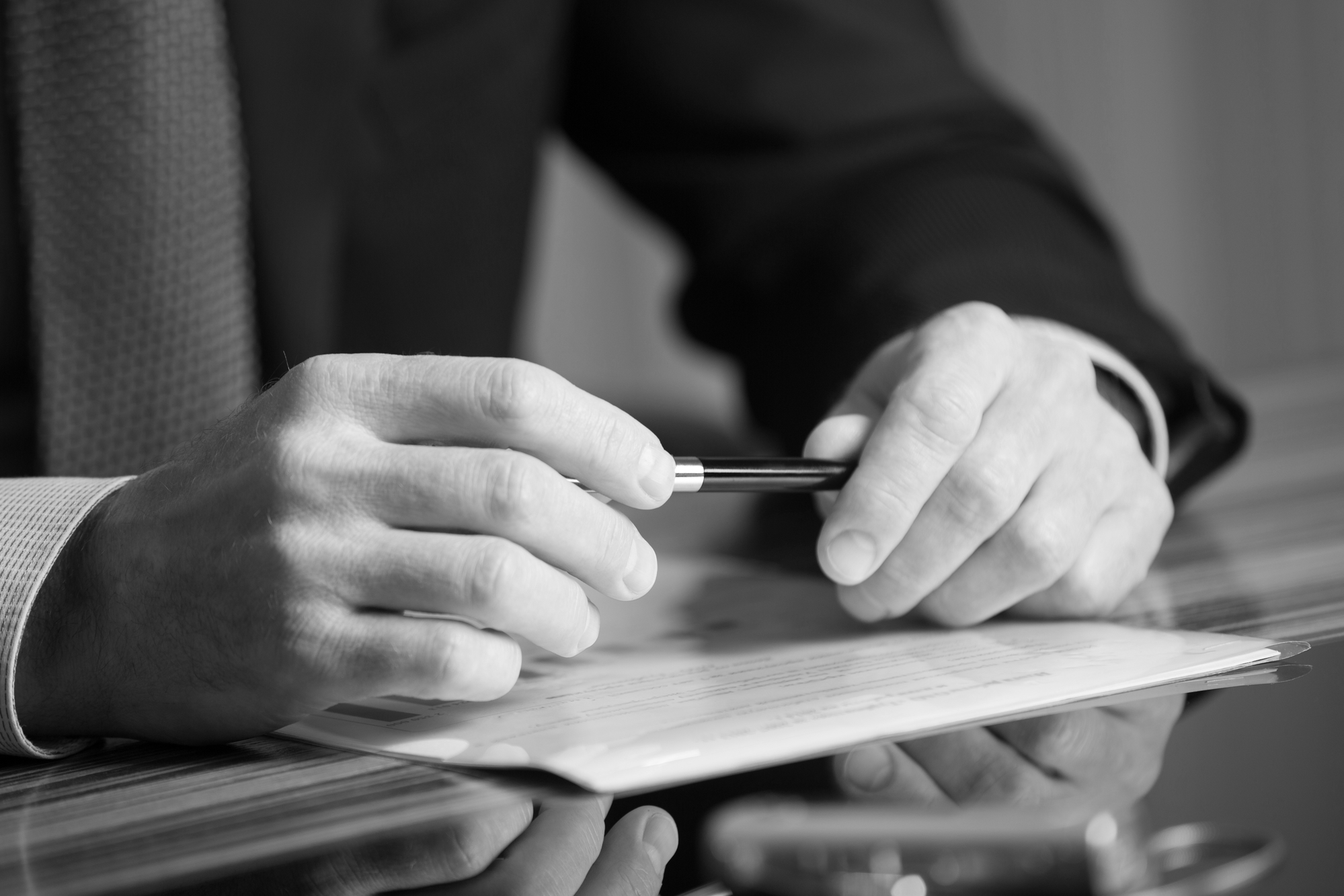 black and white photo of lawyer holding pen and documents