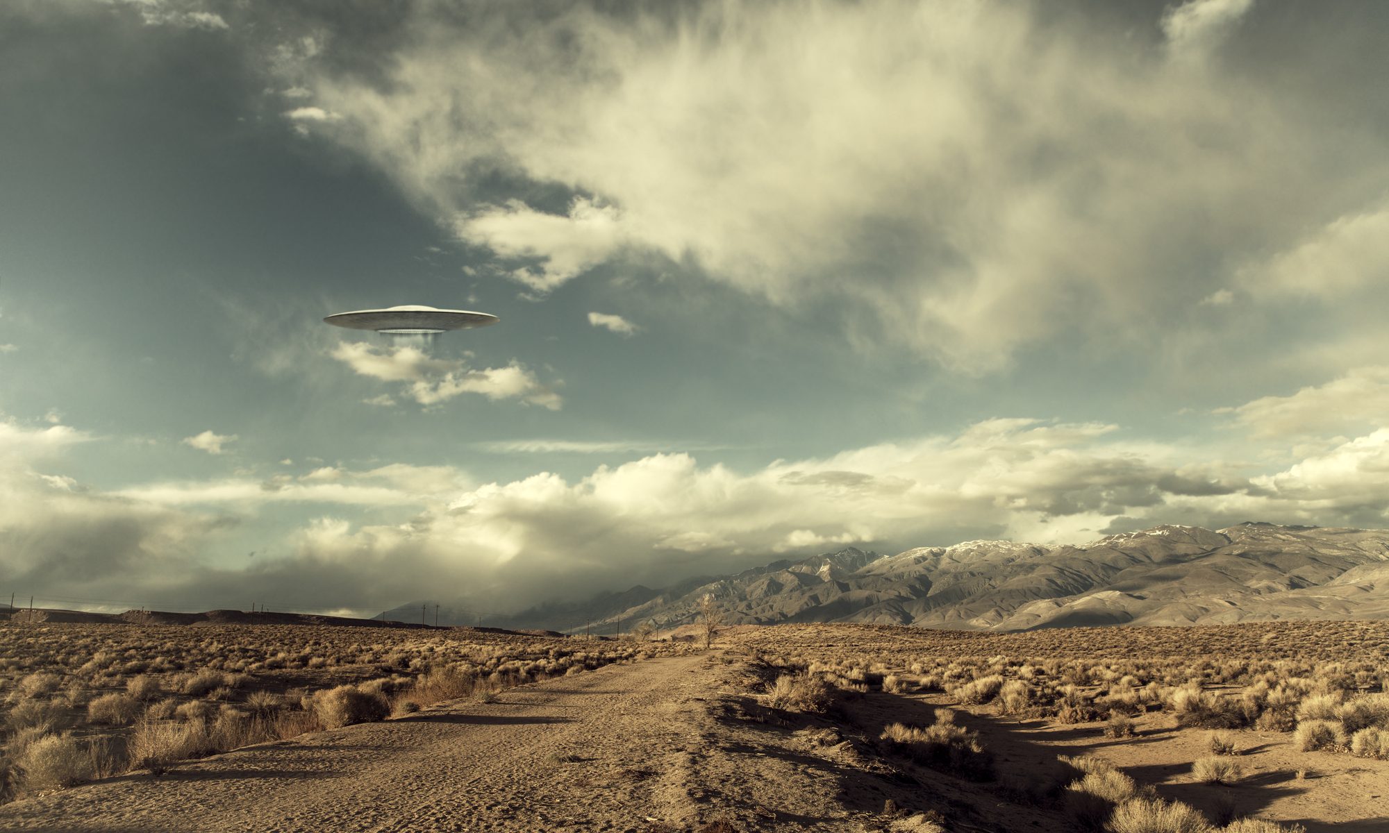 image of ufo hovering over desert road