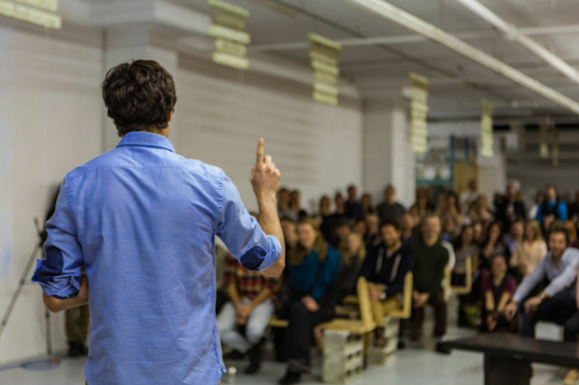 photograph of teacher presenting to packed classroom