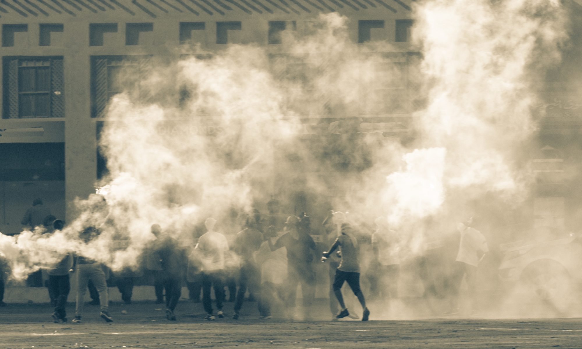 photograph of rioters hidden in smoke