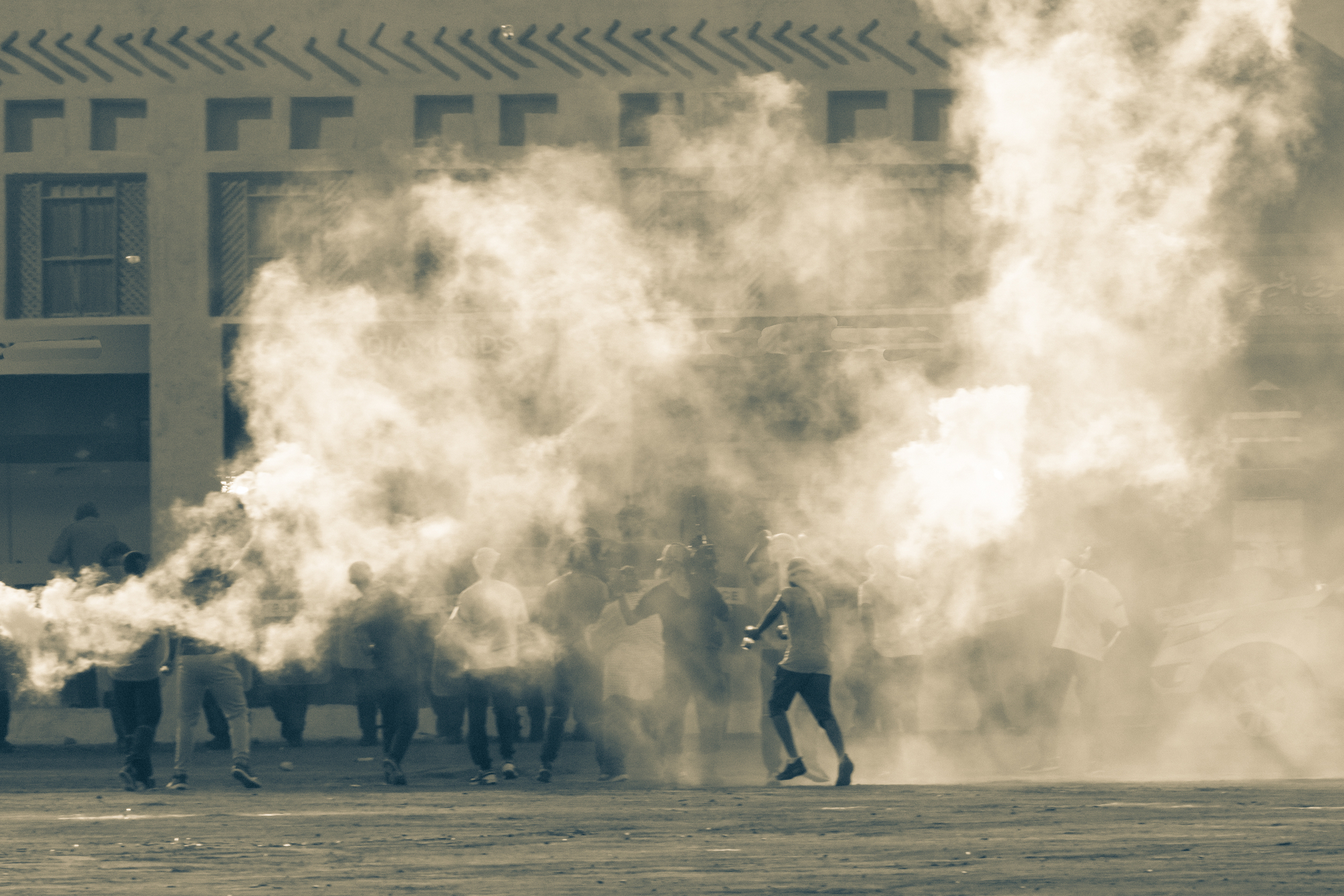 photograph of rioters hidden in smoke