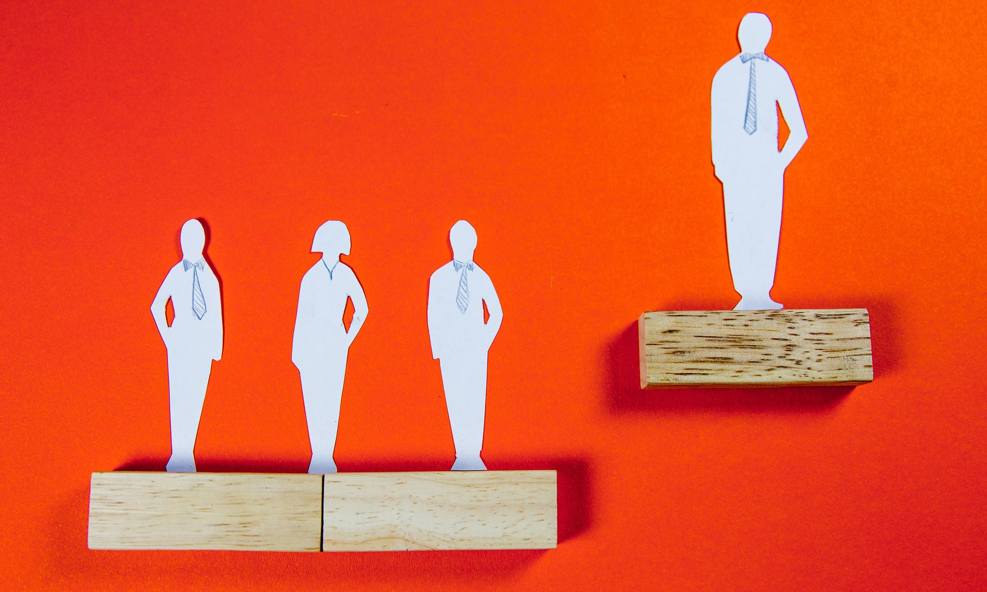 cutout of white man on corporate ladder elevated above peers
