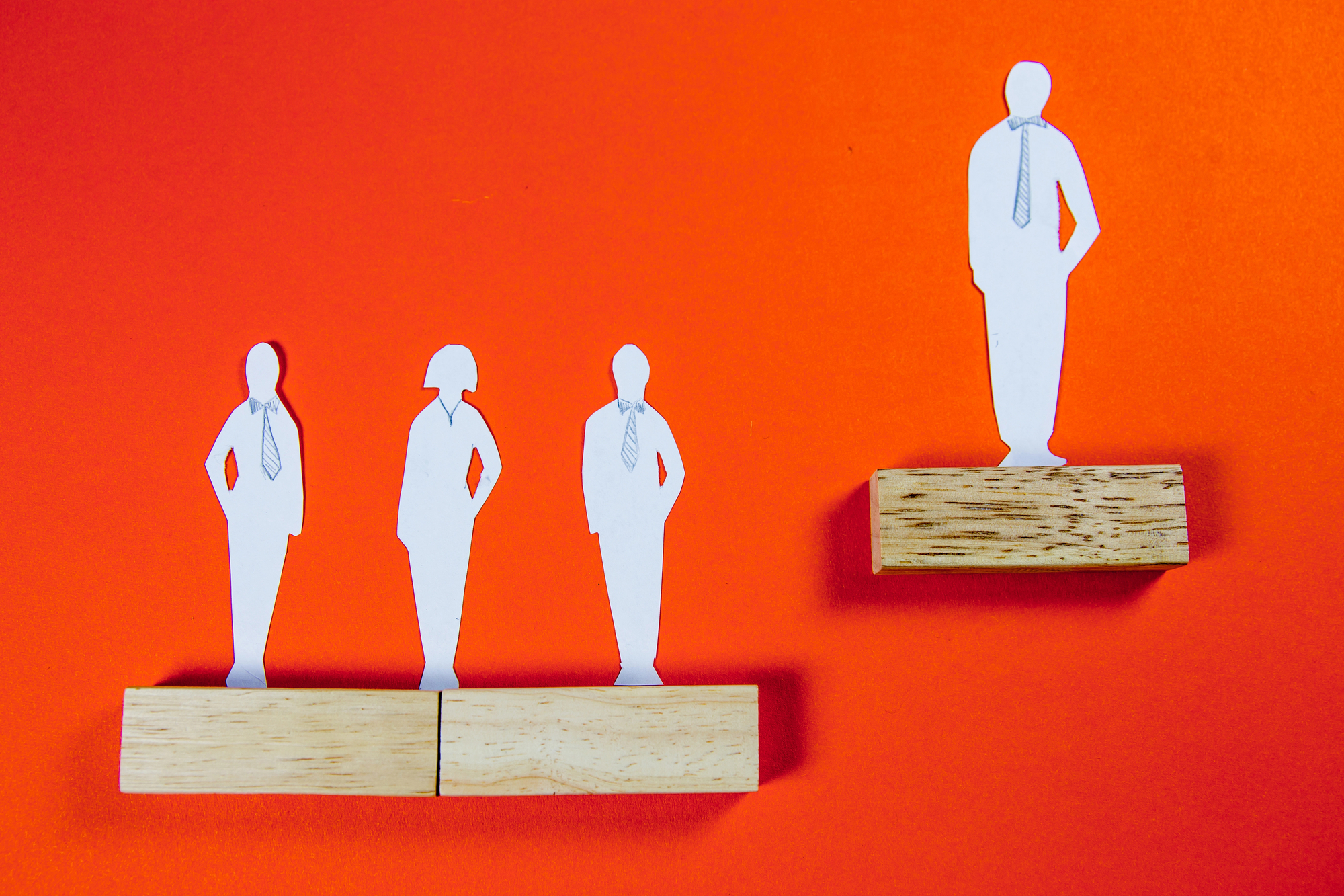 cutout of white man on corporate ladder elevated above peers