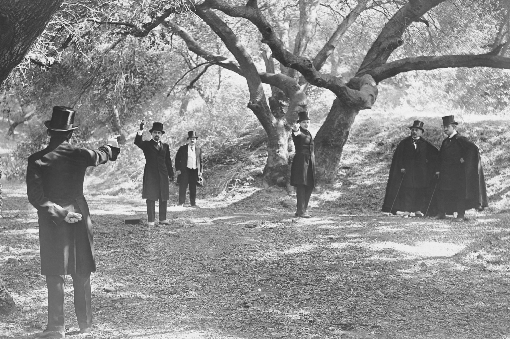 black-and-white photograph of gentlemen engaged in gun duel