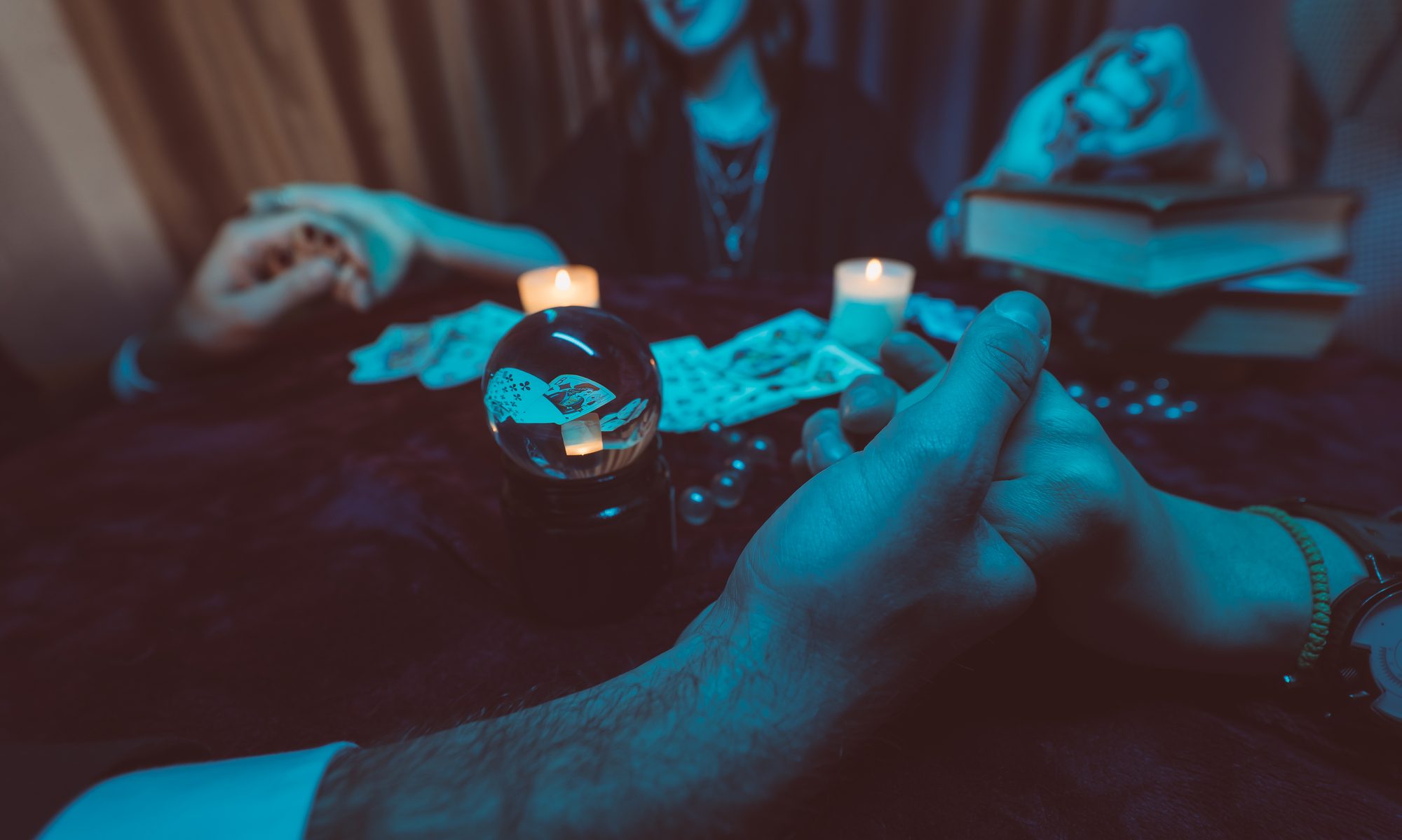 photograph of patrons holding hands at seance