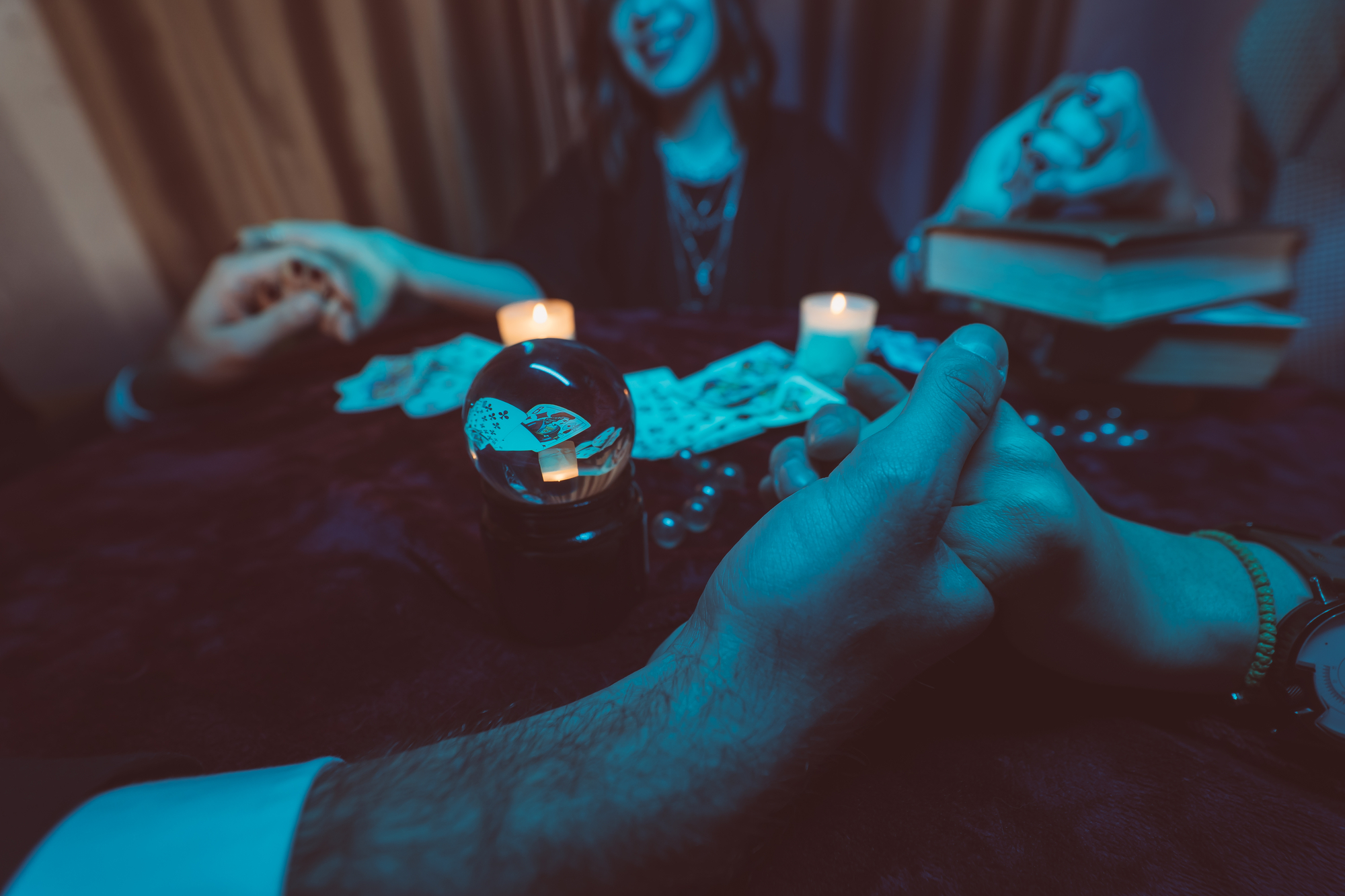 photograph of patrons holding hands at seance