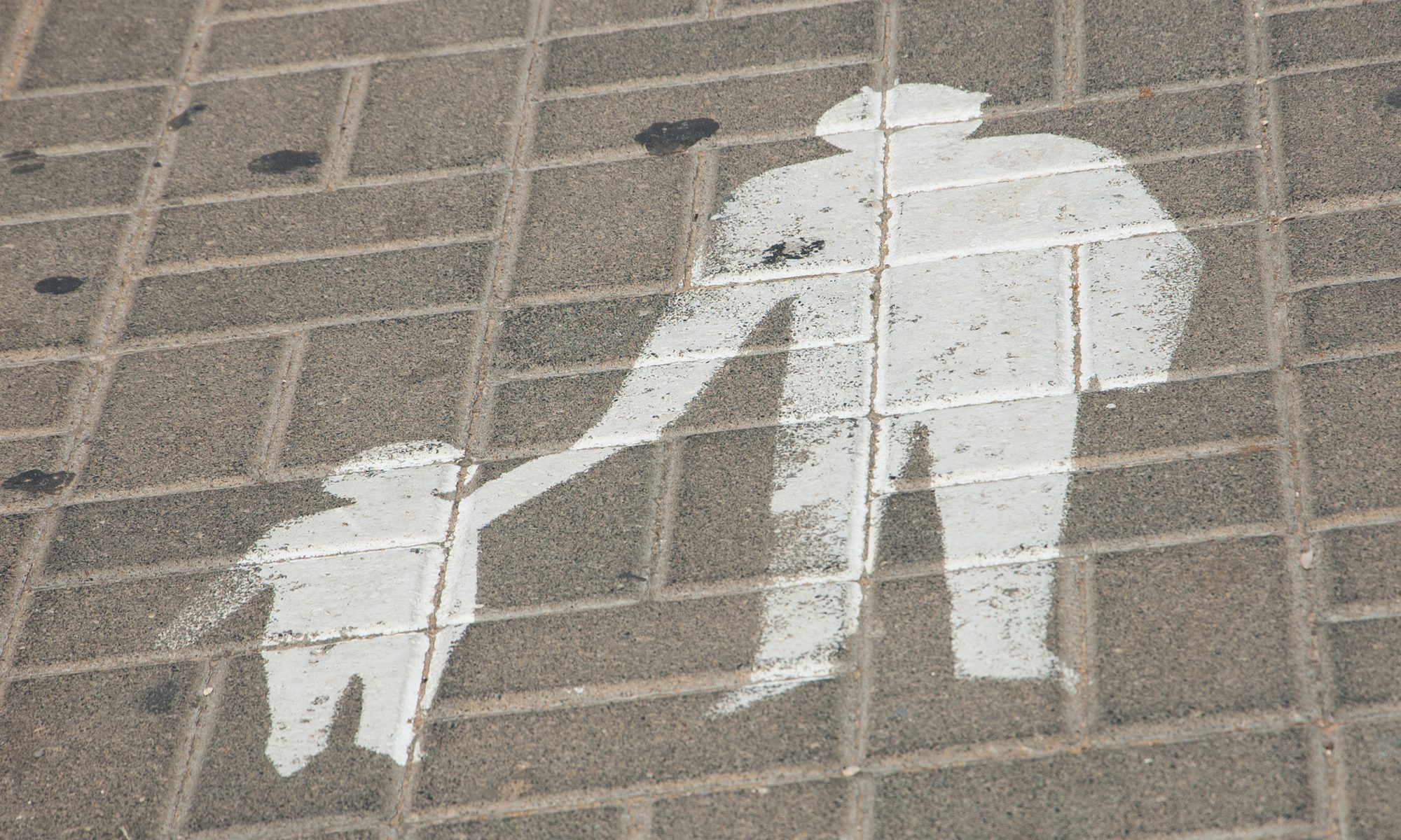 photograph of parent/child pedestrian sign on tile pavement